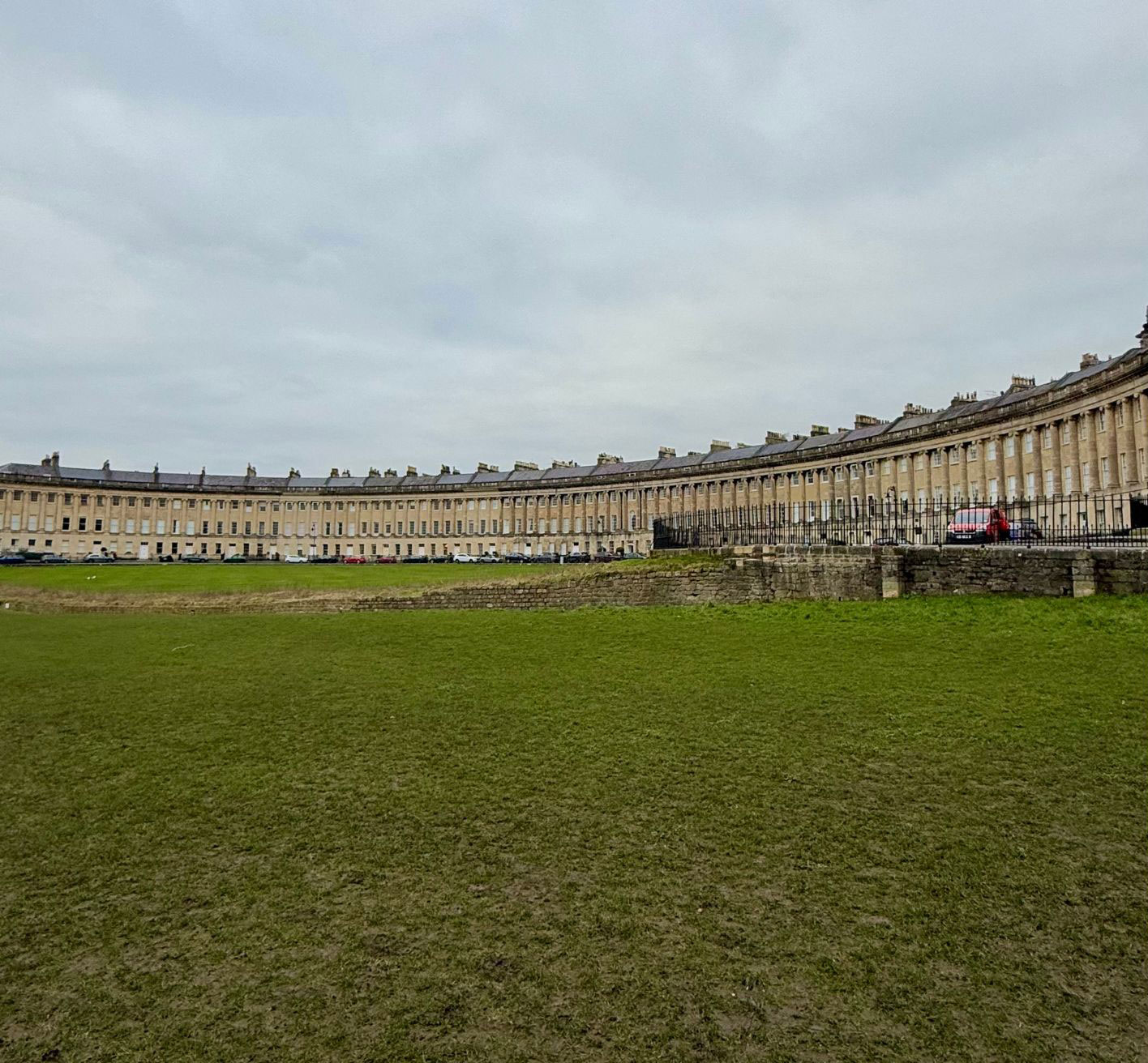 Curving stone terrace overlooking a broad lawn in Bath