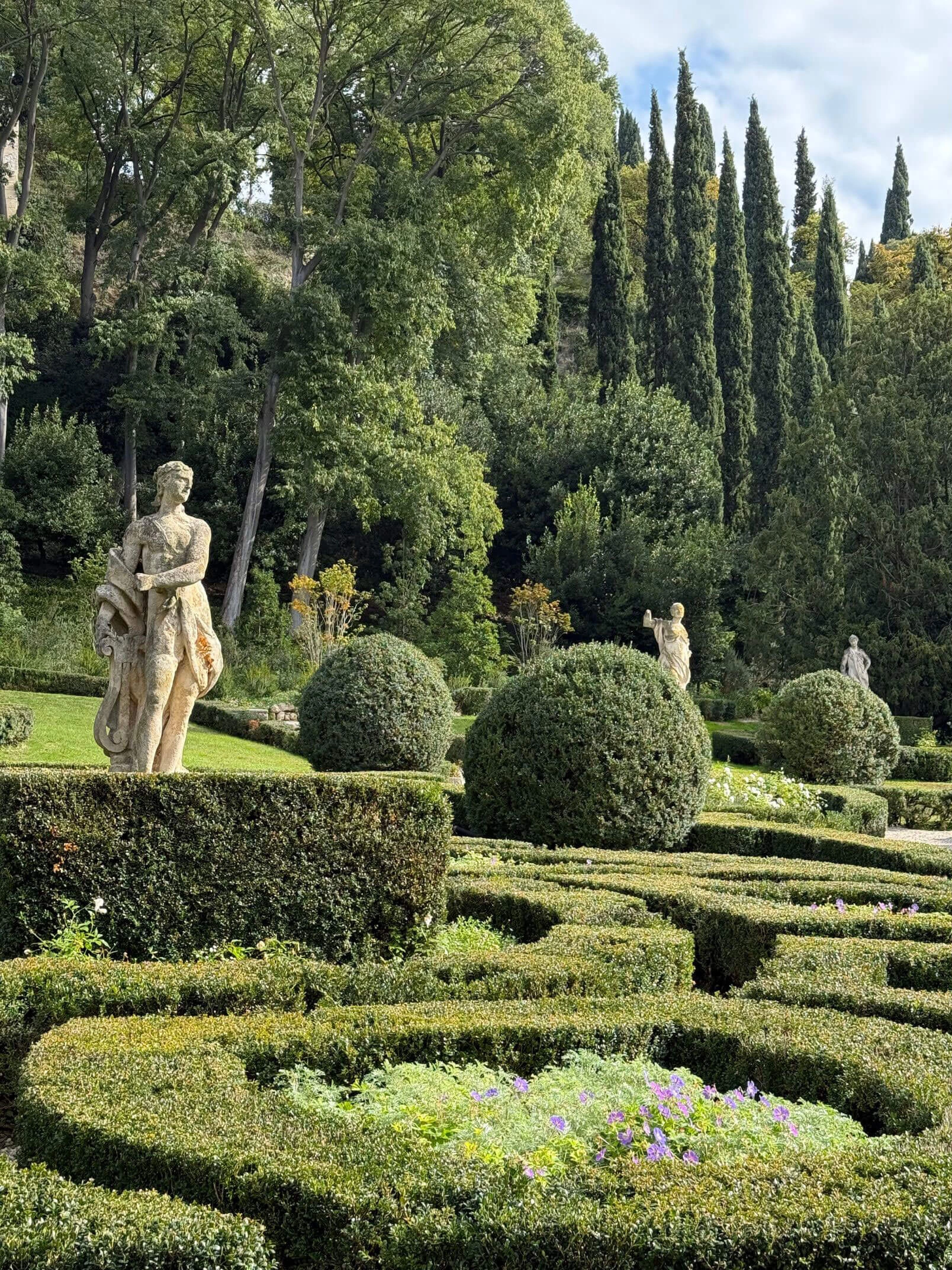 Formal hedges and statues beneath the cypresses of Giardino Giusti