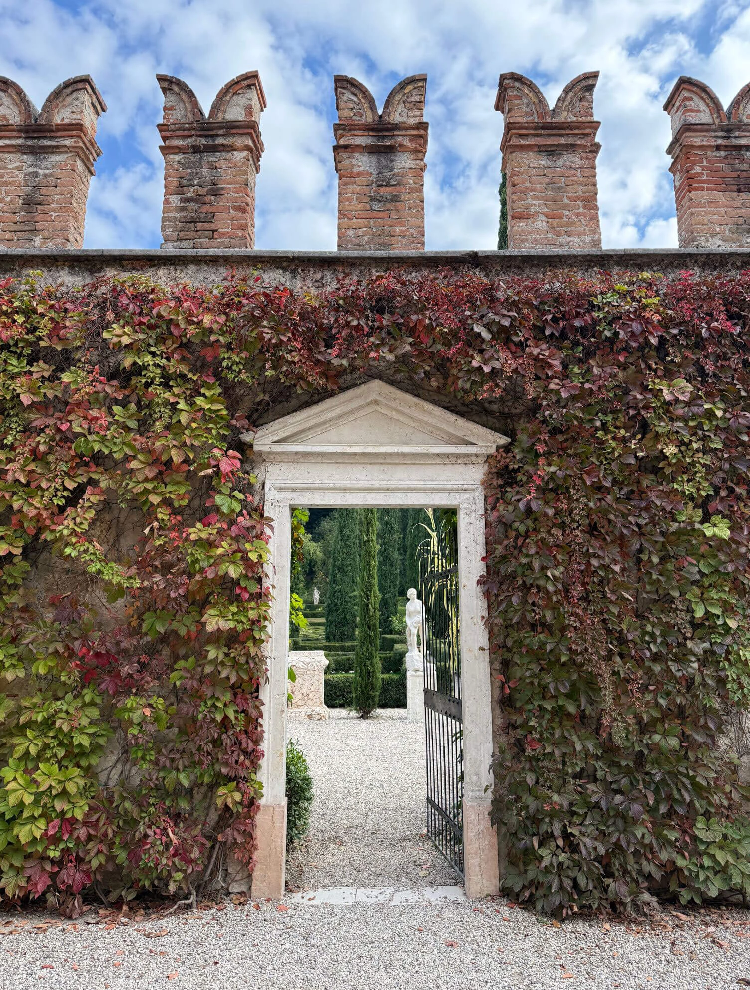Ivy-covered crenellated wall framing an open doorway