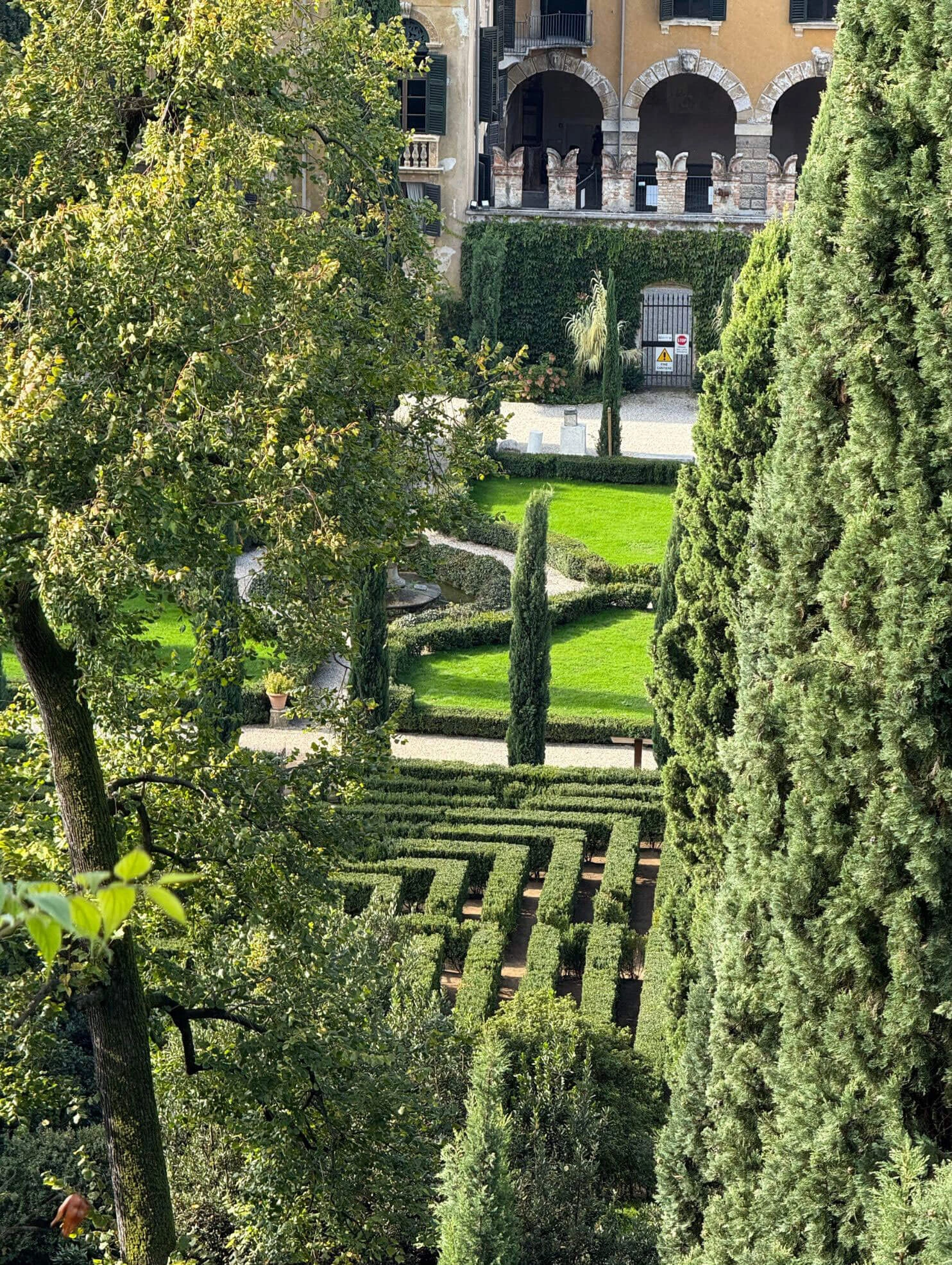 Elevated view of a hedge maze and palazzo garden