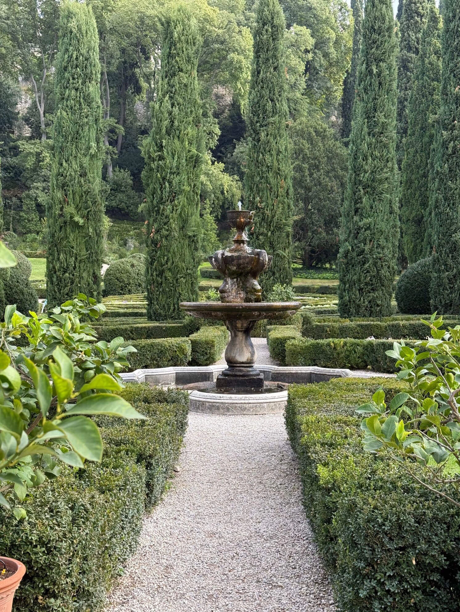Gravel path approaching a tiered fountain