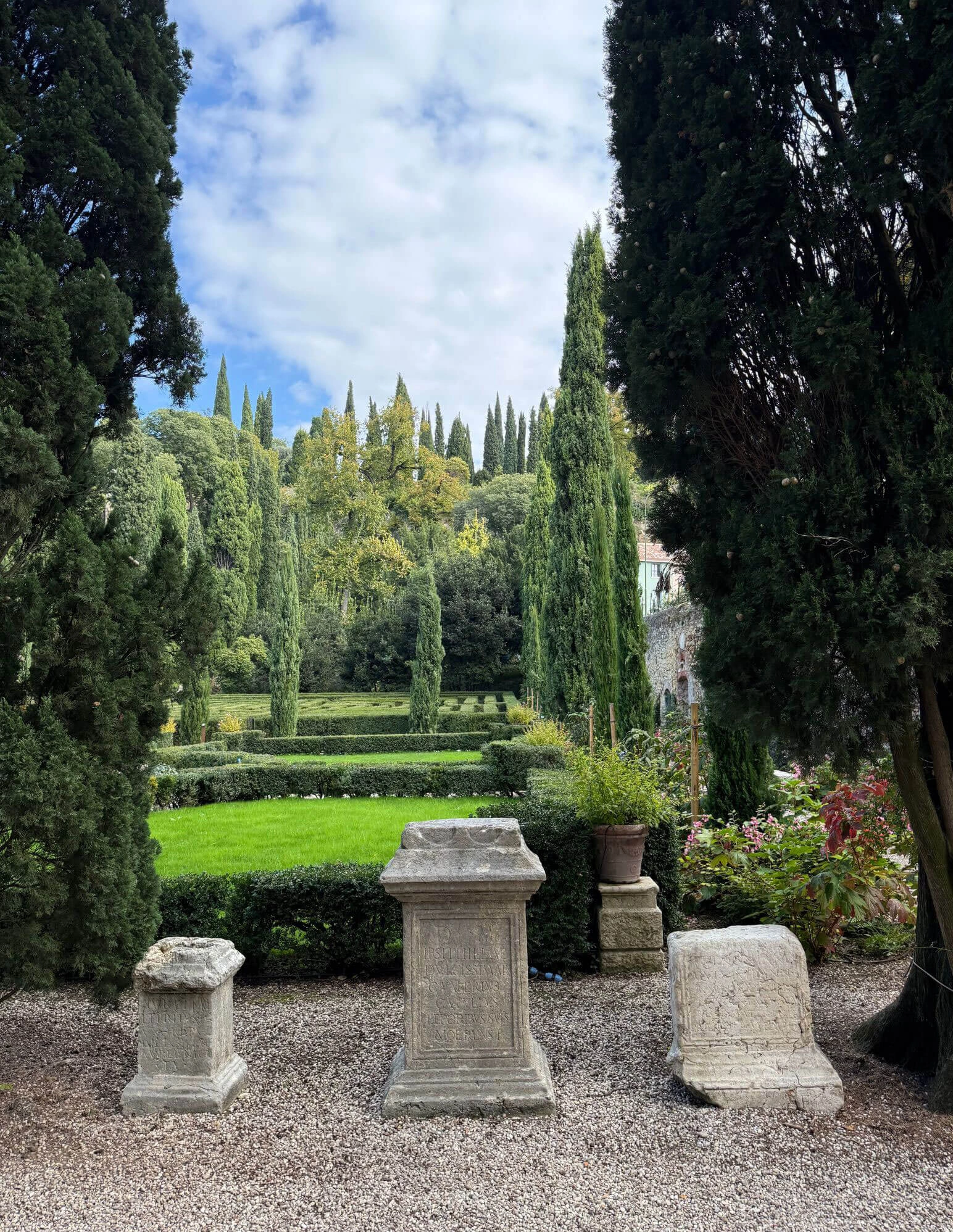 Stone seats at the edge of a formal garden vista