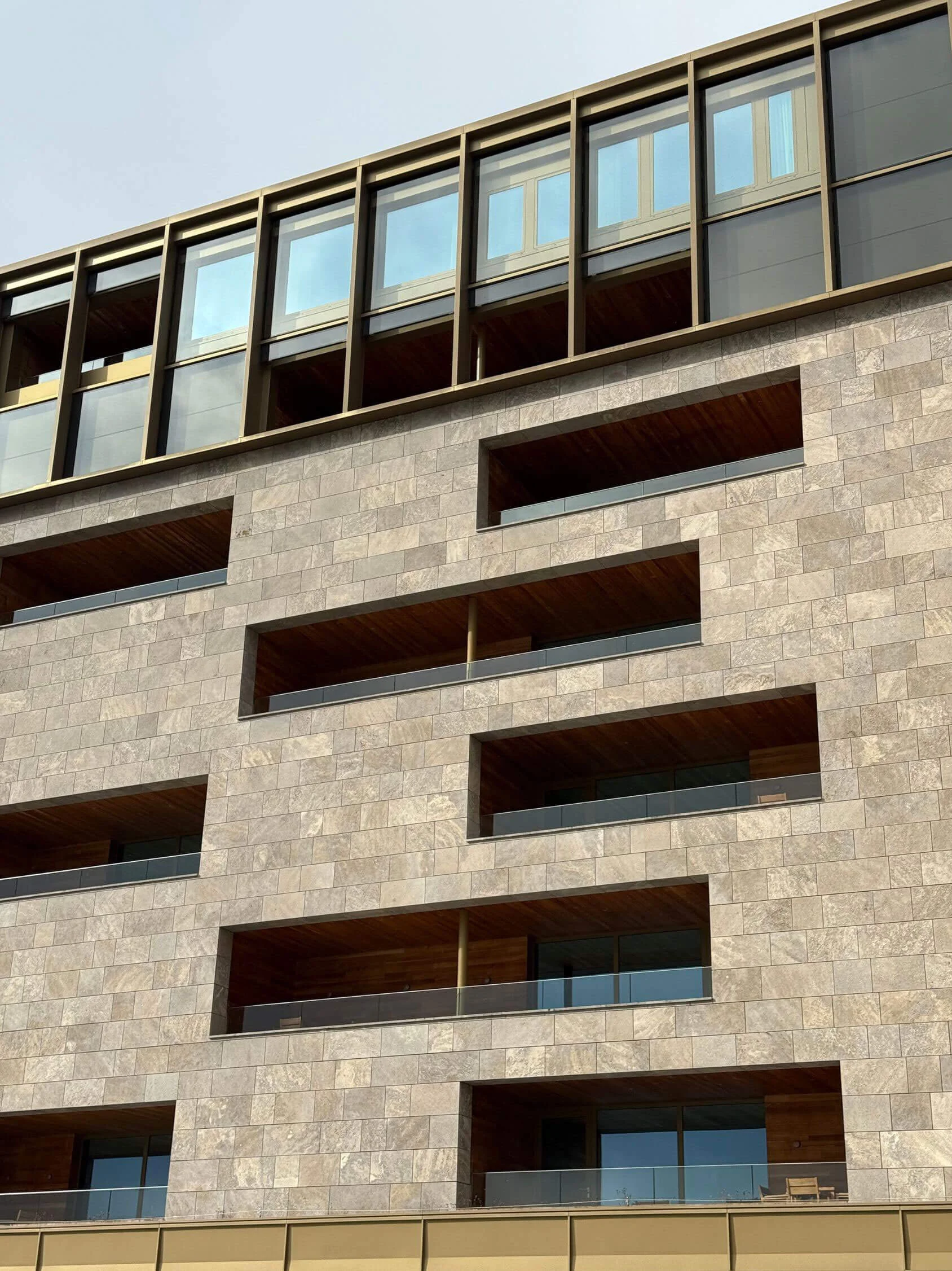 Recessed windows in a limestone hotel facade