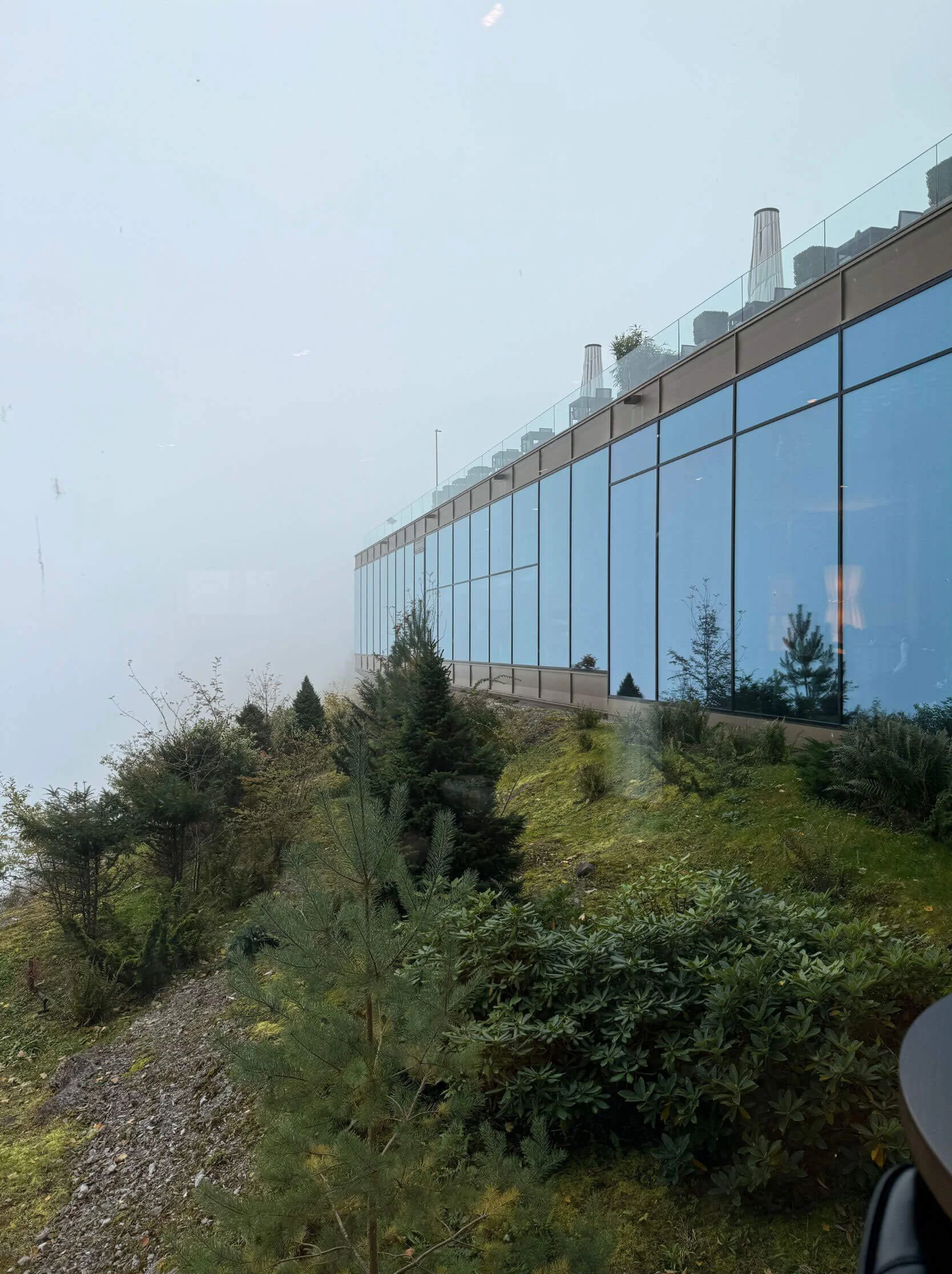Long glazed facade following the slope of the land