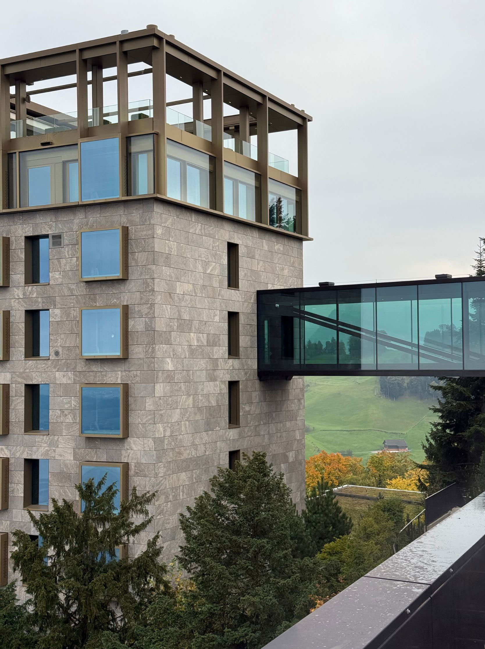 Stone hotel tower and elevated glass connection