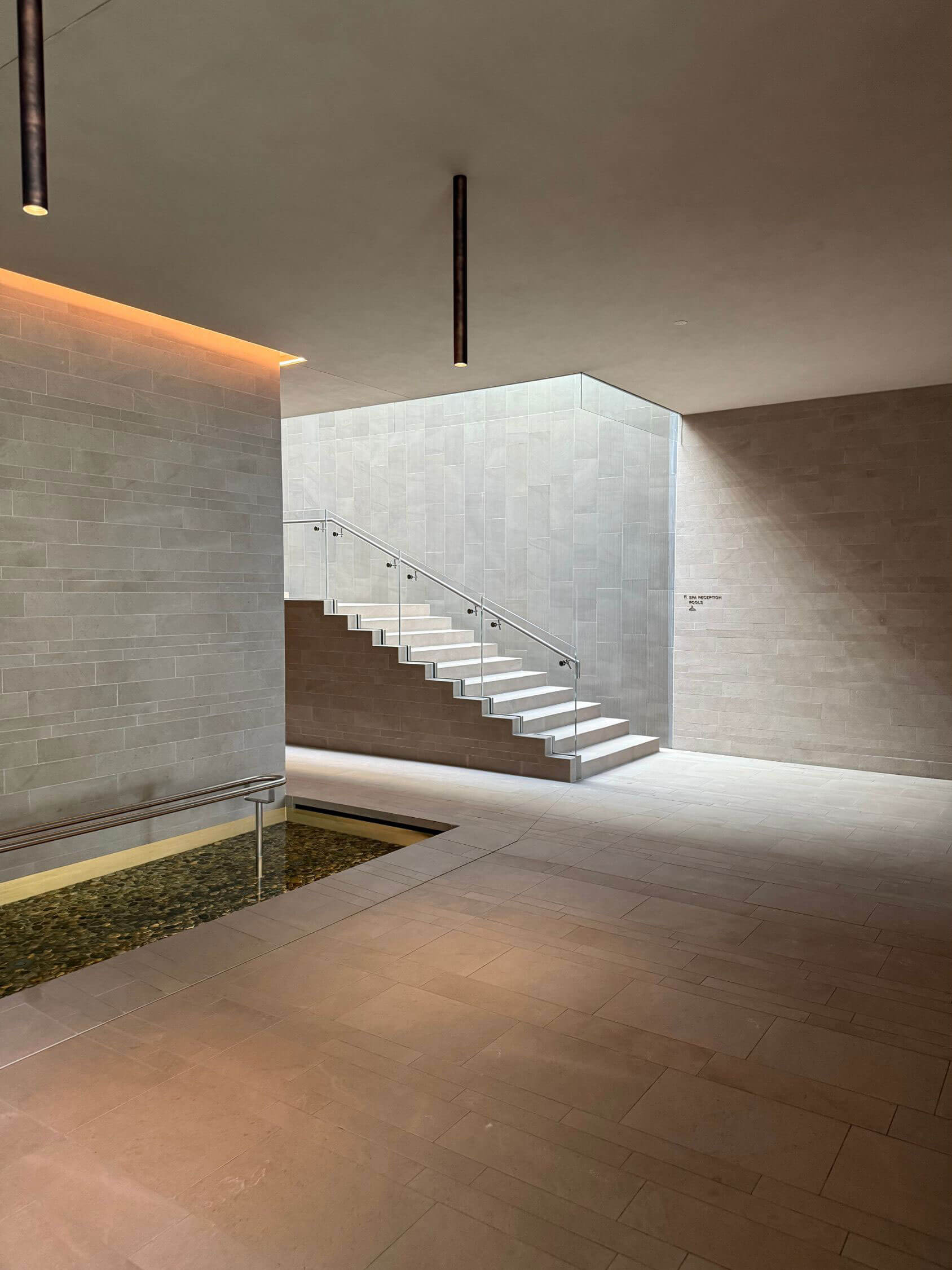 Minimal stone interior with a sculptural stairway