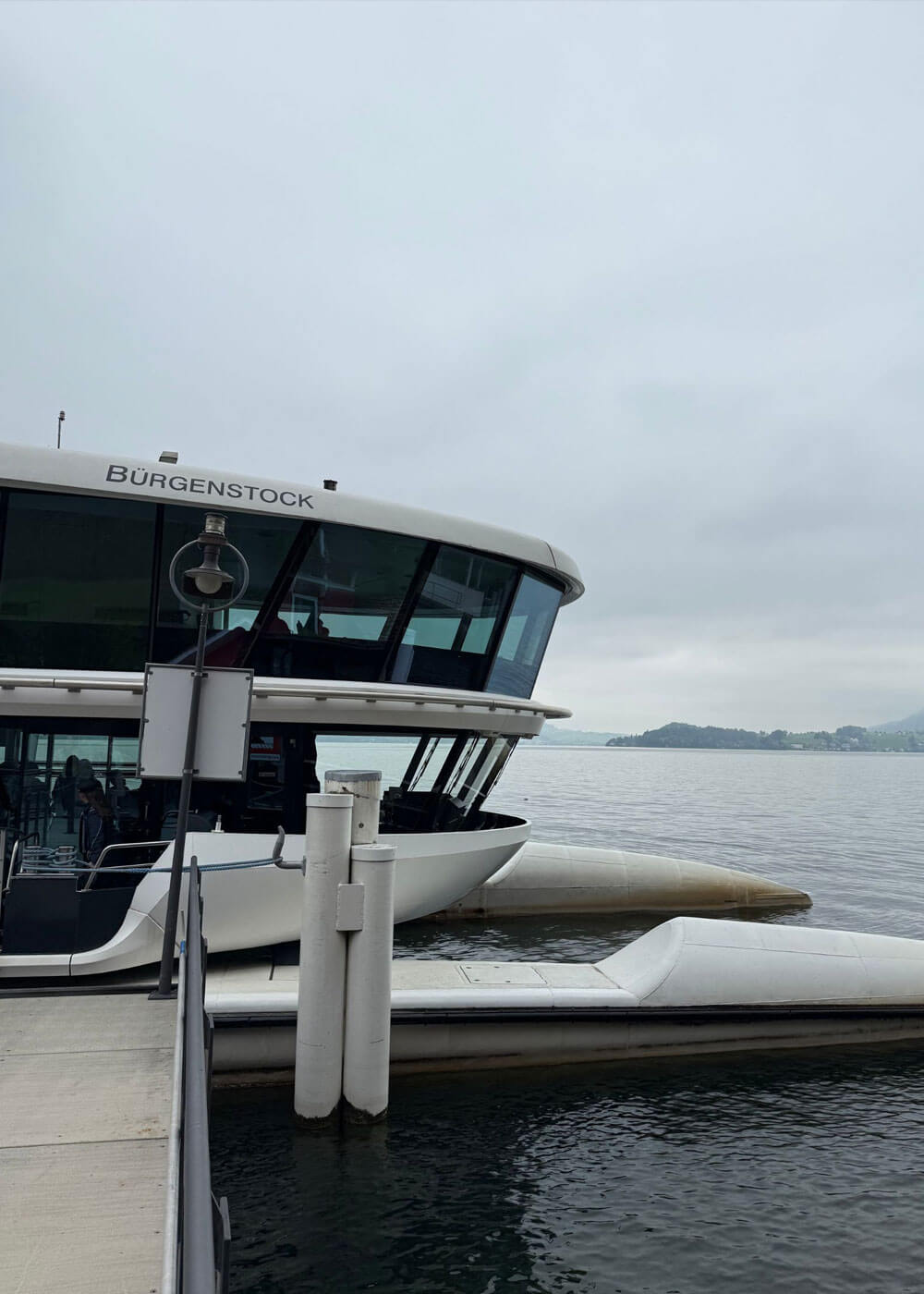 Passenger ferry moored beside a lakeside dock