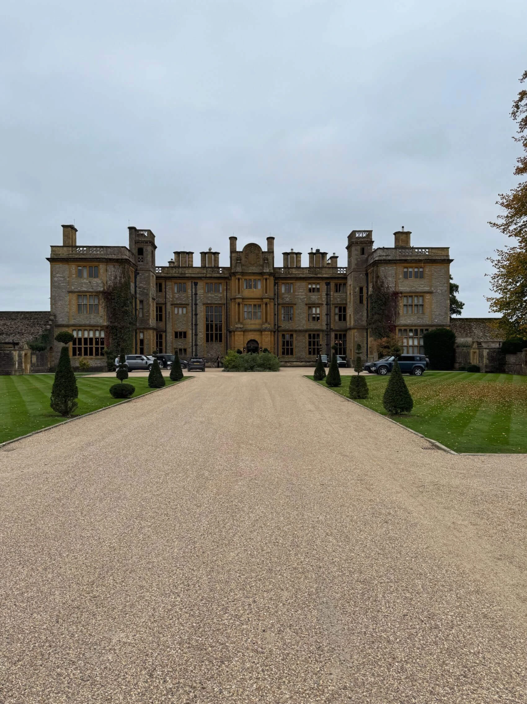 Gravel drive approaching the symmetrical manor facade