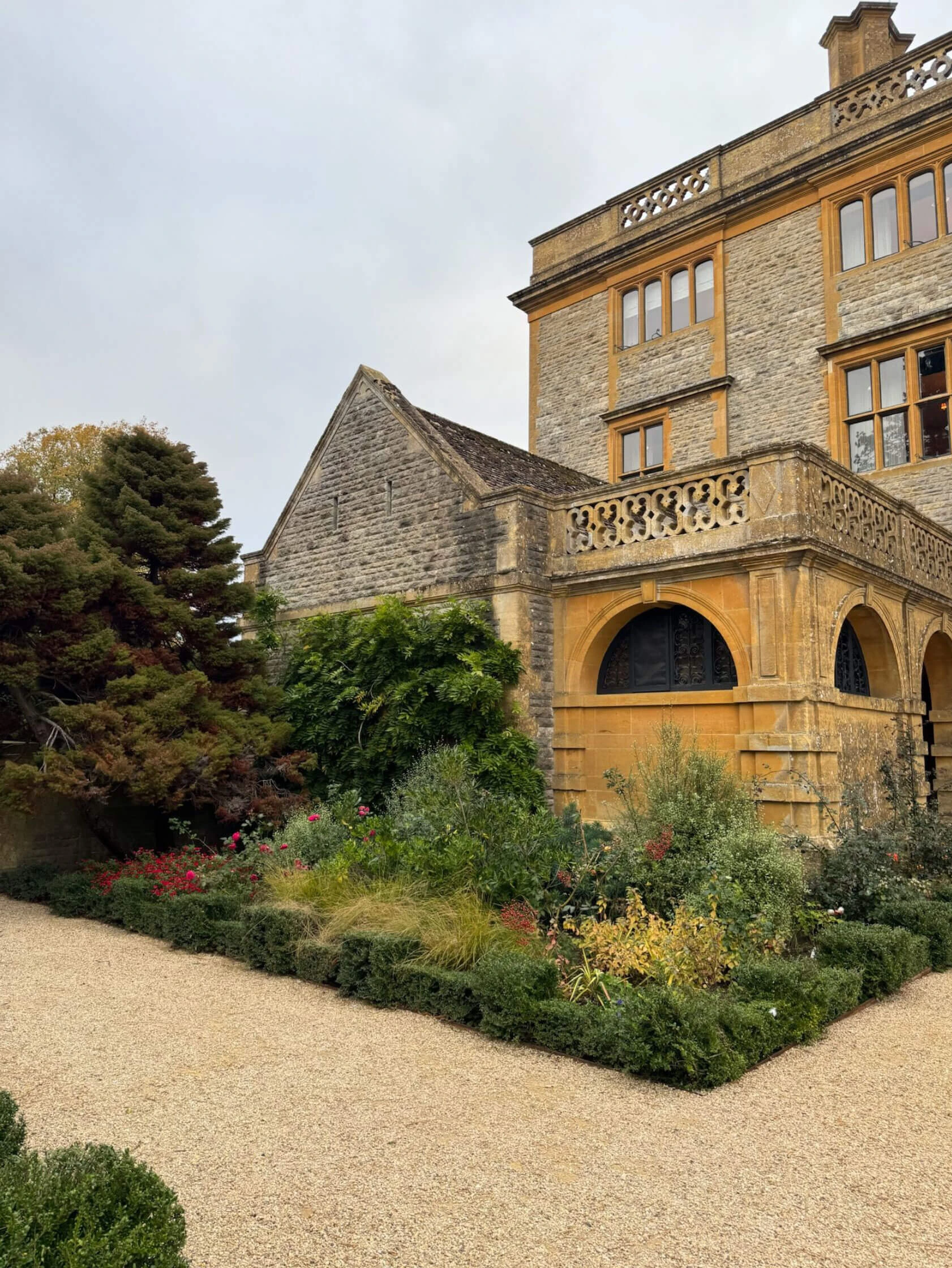 Stone terrace and balustrade beside a planted border