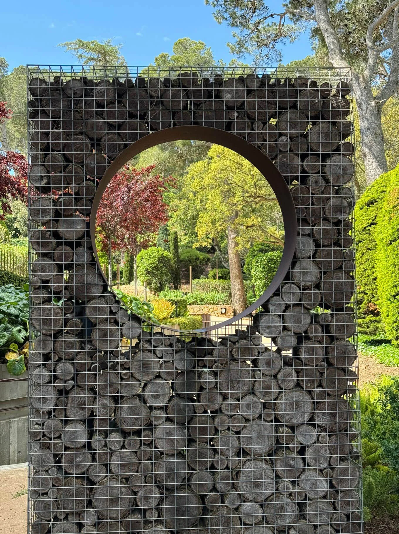 Circular opening through a wall of wire-bound stones