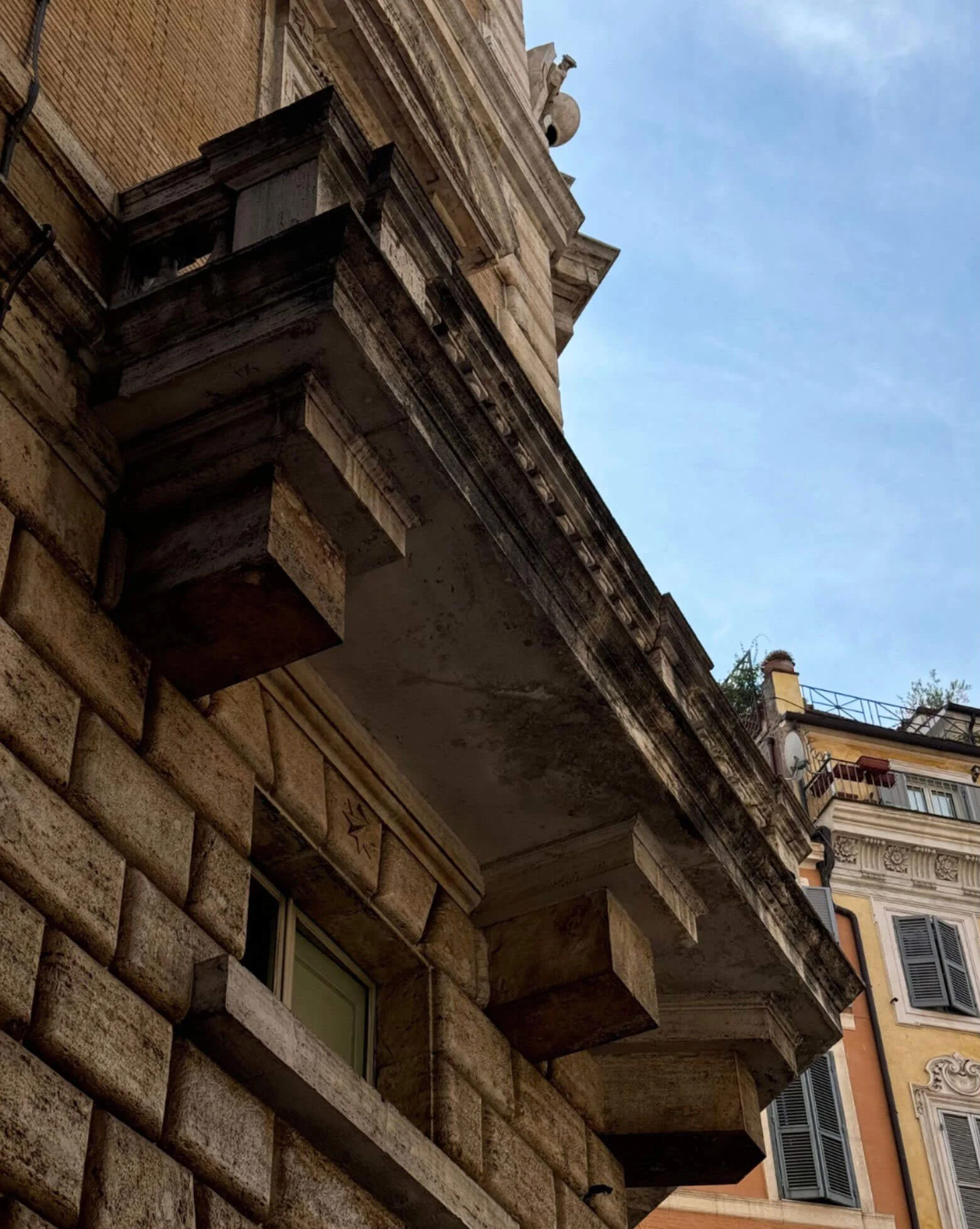 Heavy stone balcony supports viewed from the street