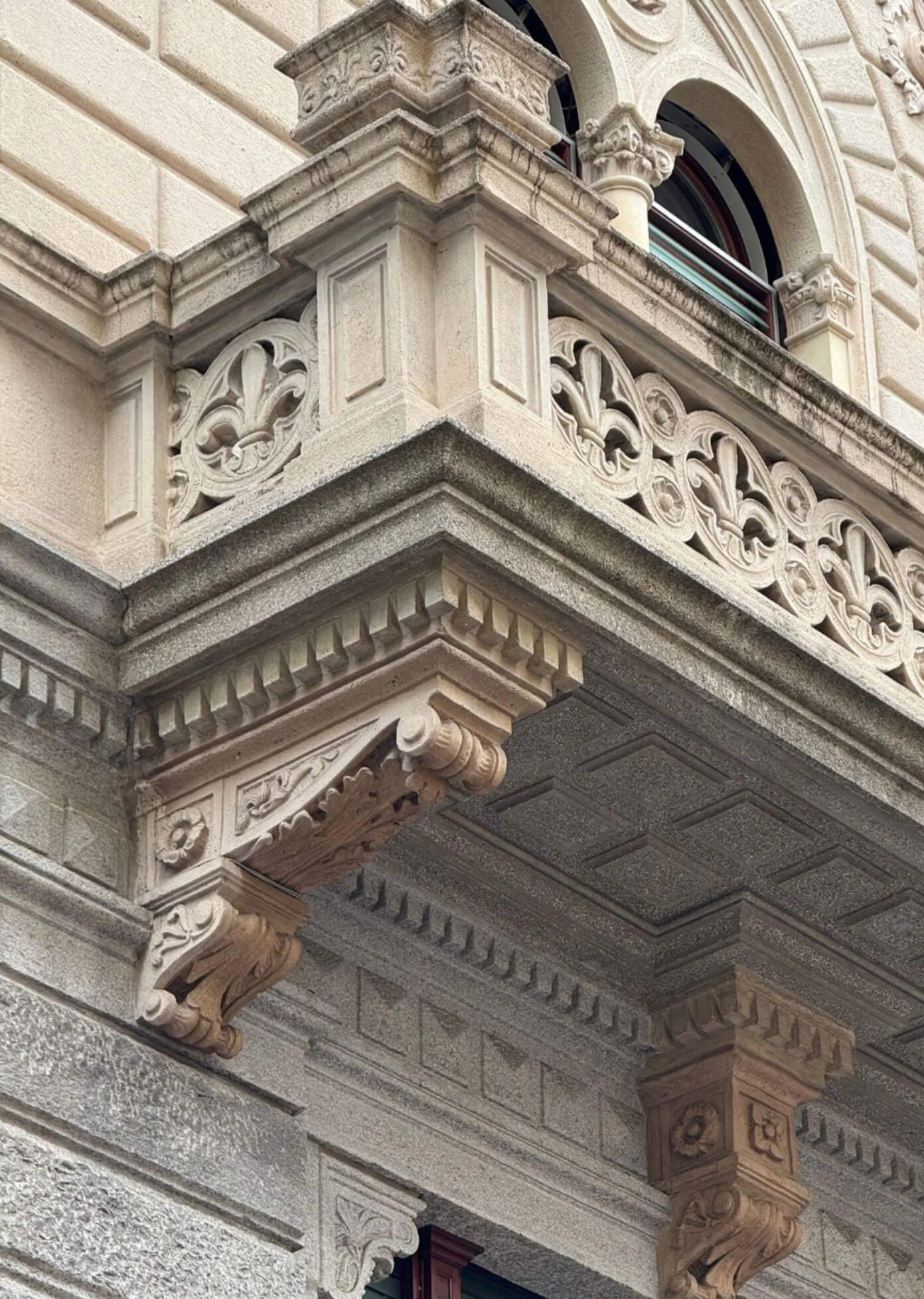 Corner balcony with intricate carved stone panels