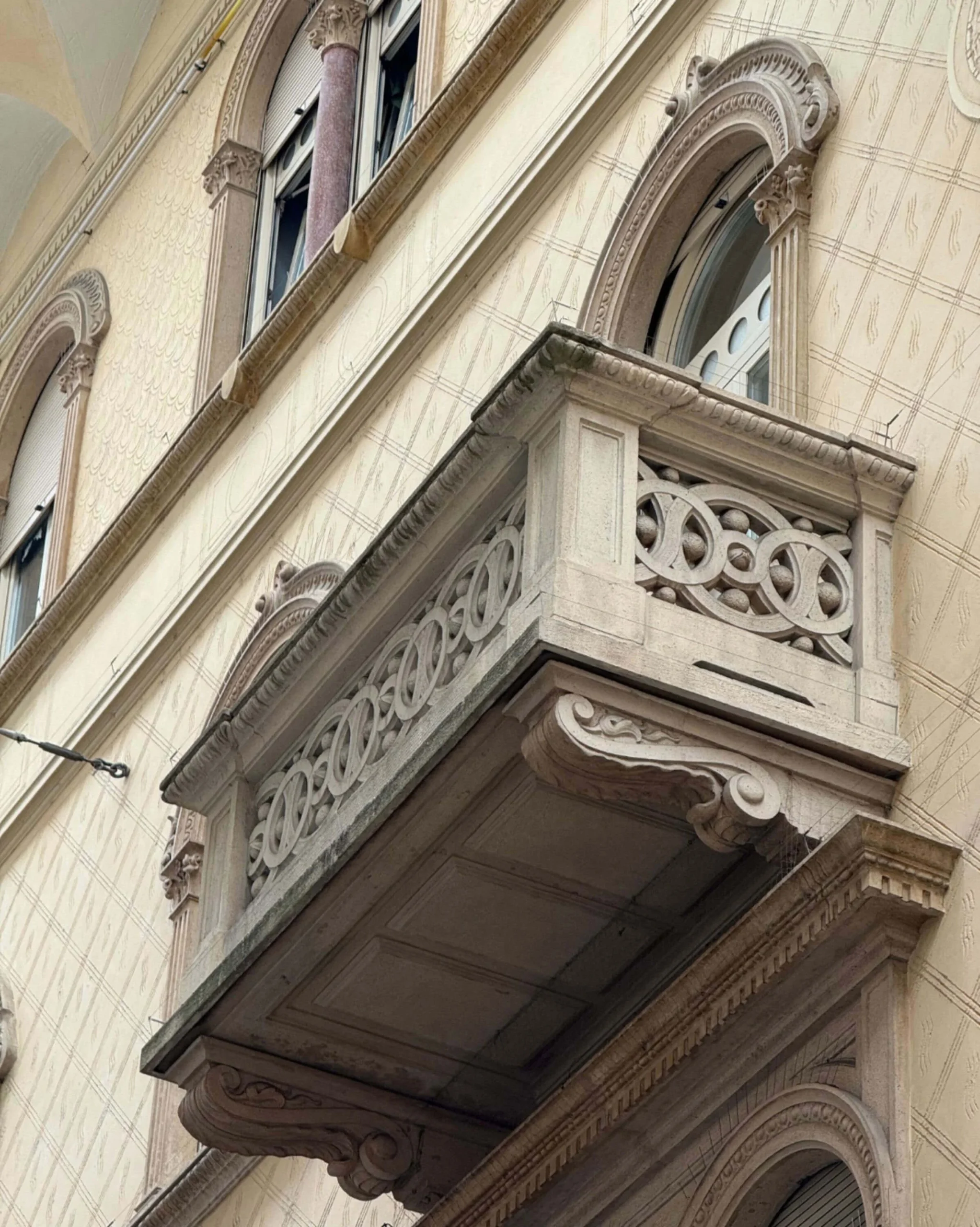 Ornate stone balcony with pierced railing panels
