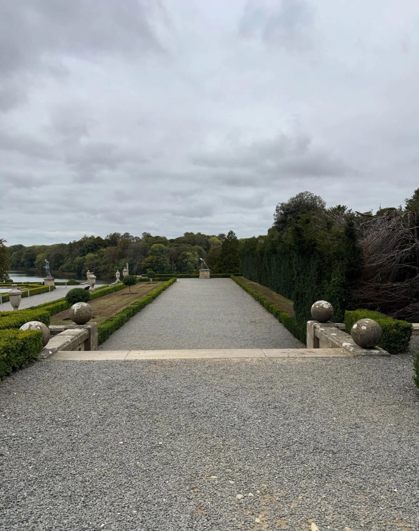 Gravel garden terrace overlooking formal water gardens