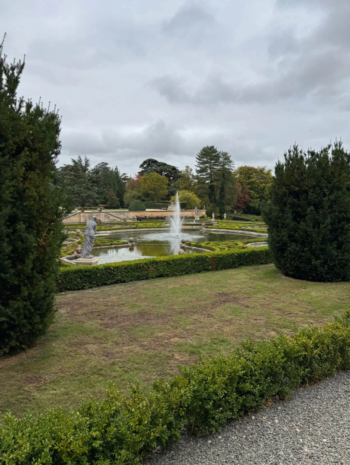 Fountain garden framed by clipped hedges
