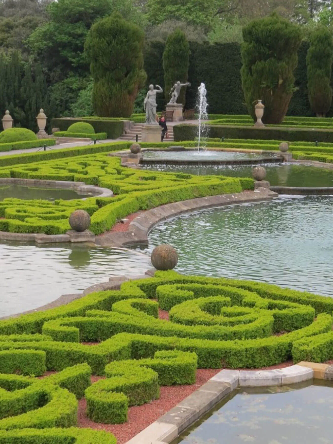 Ornamental hedges beside a reflecting pool