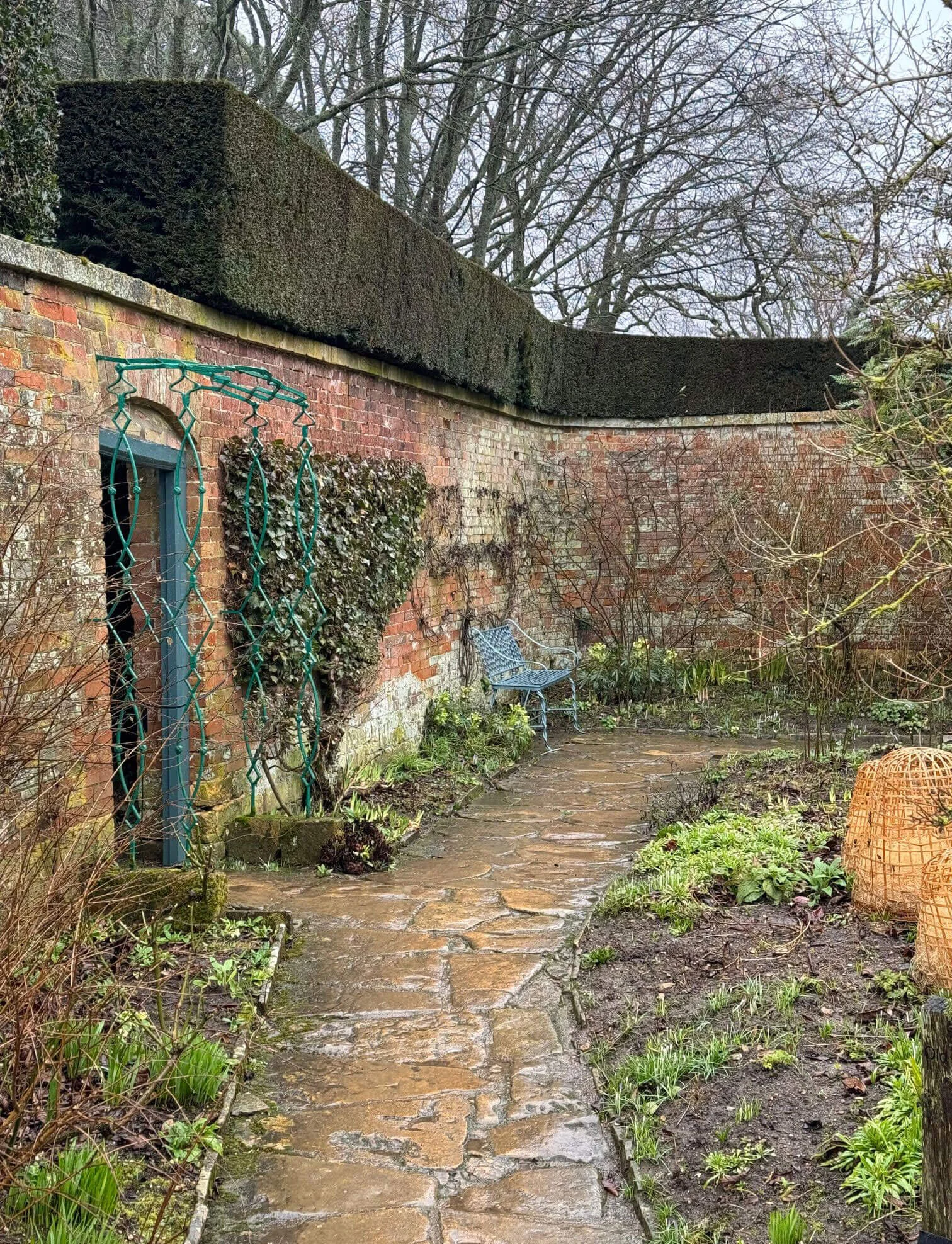 Weathered brick garden walls enclosing a curved stone path