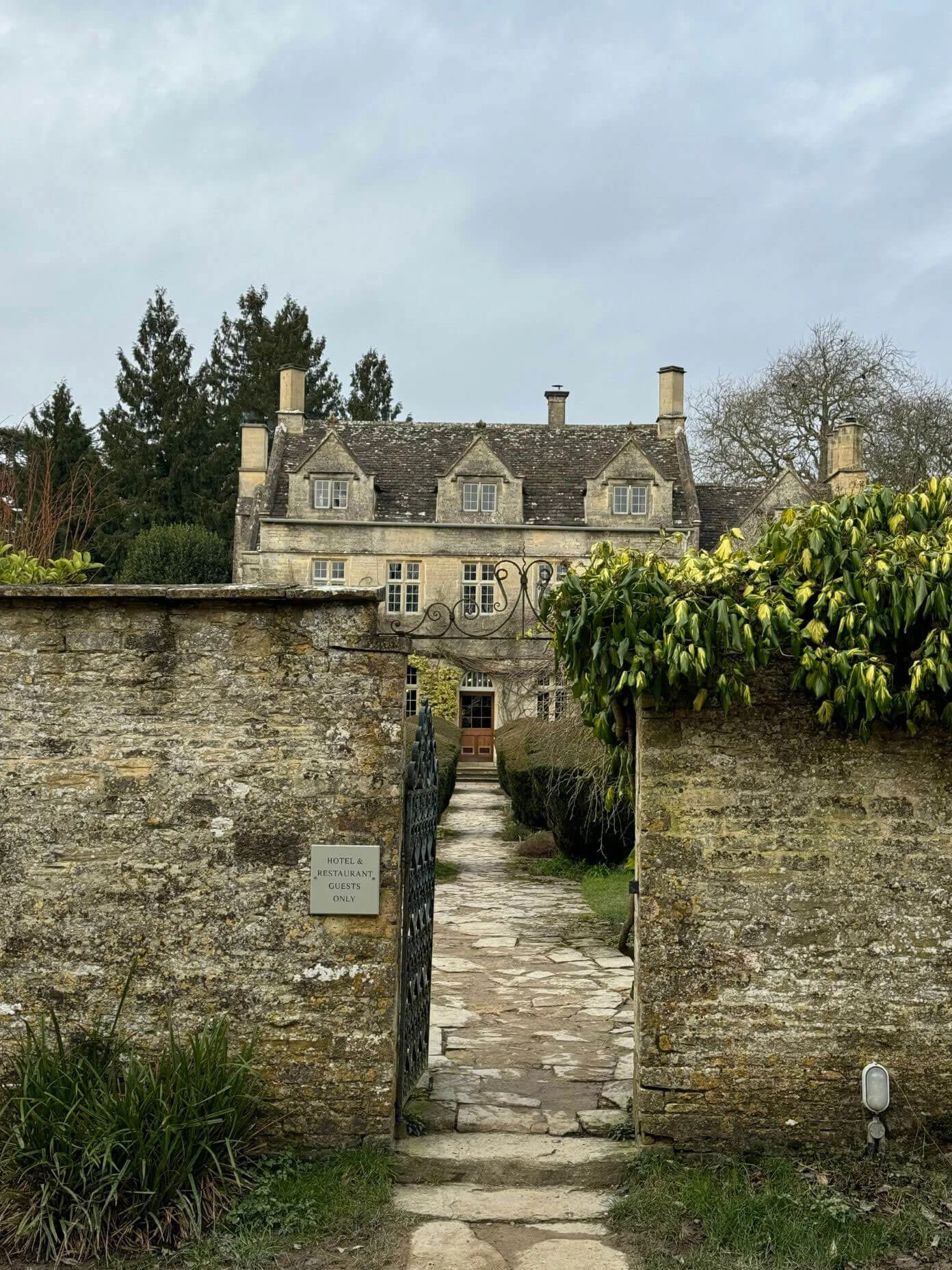 Country manor seen beyond a walled garden entrance