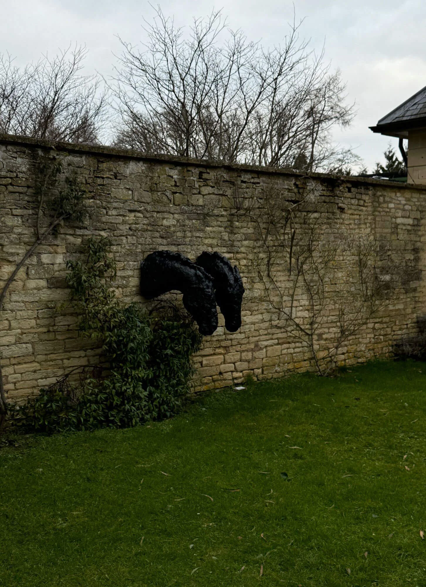 Small arched opening in a weathered garden wall