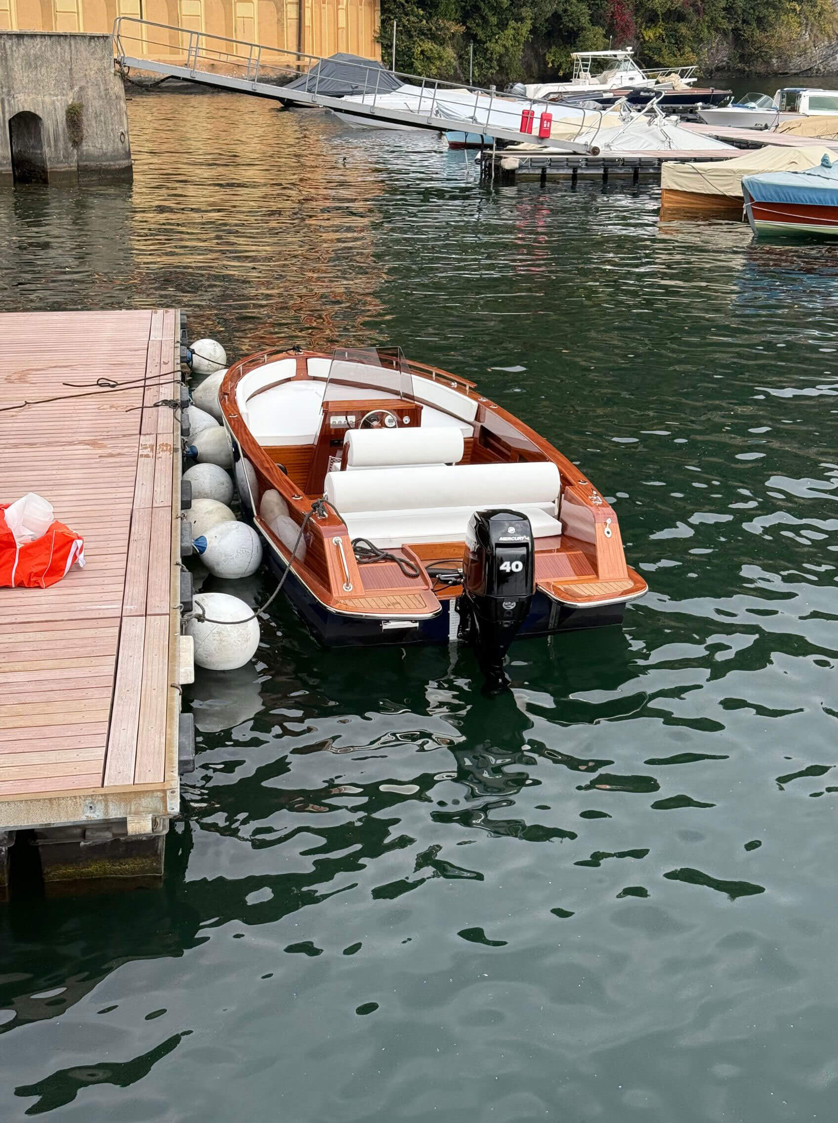 Wooden motorboat moored beside a lakeside quay