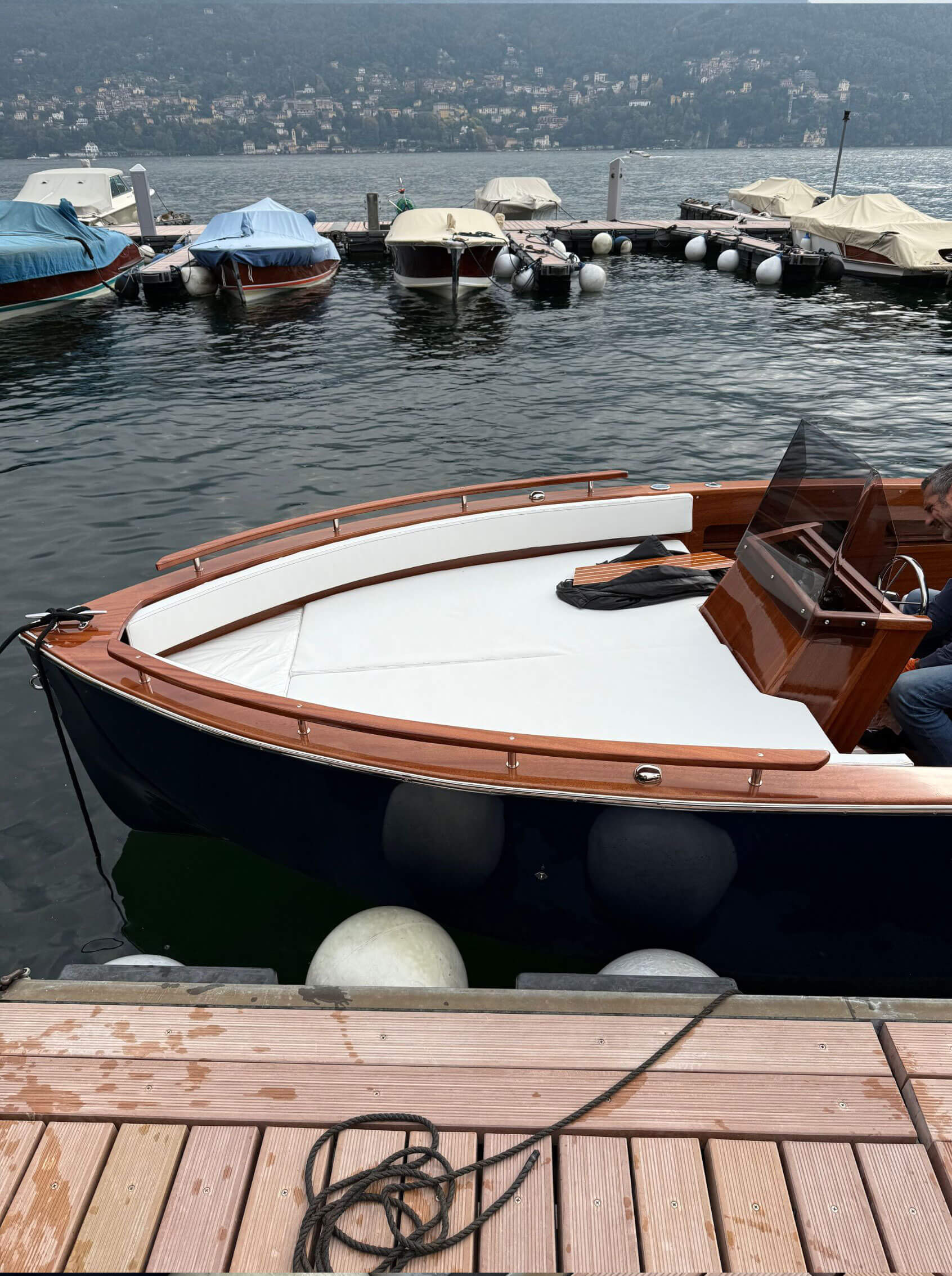 Polished wooden bow beside a lakeside mooring