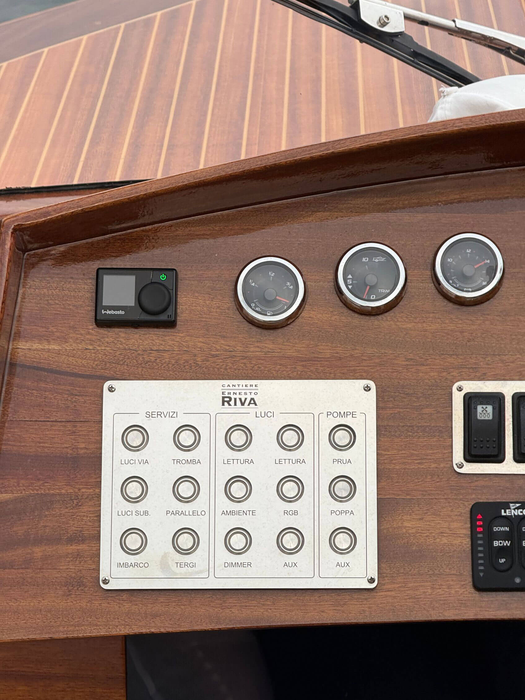 Gauges and controls set into a varnished wooden dashboard