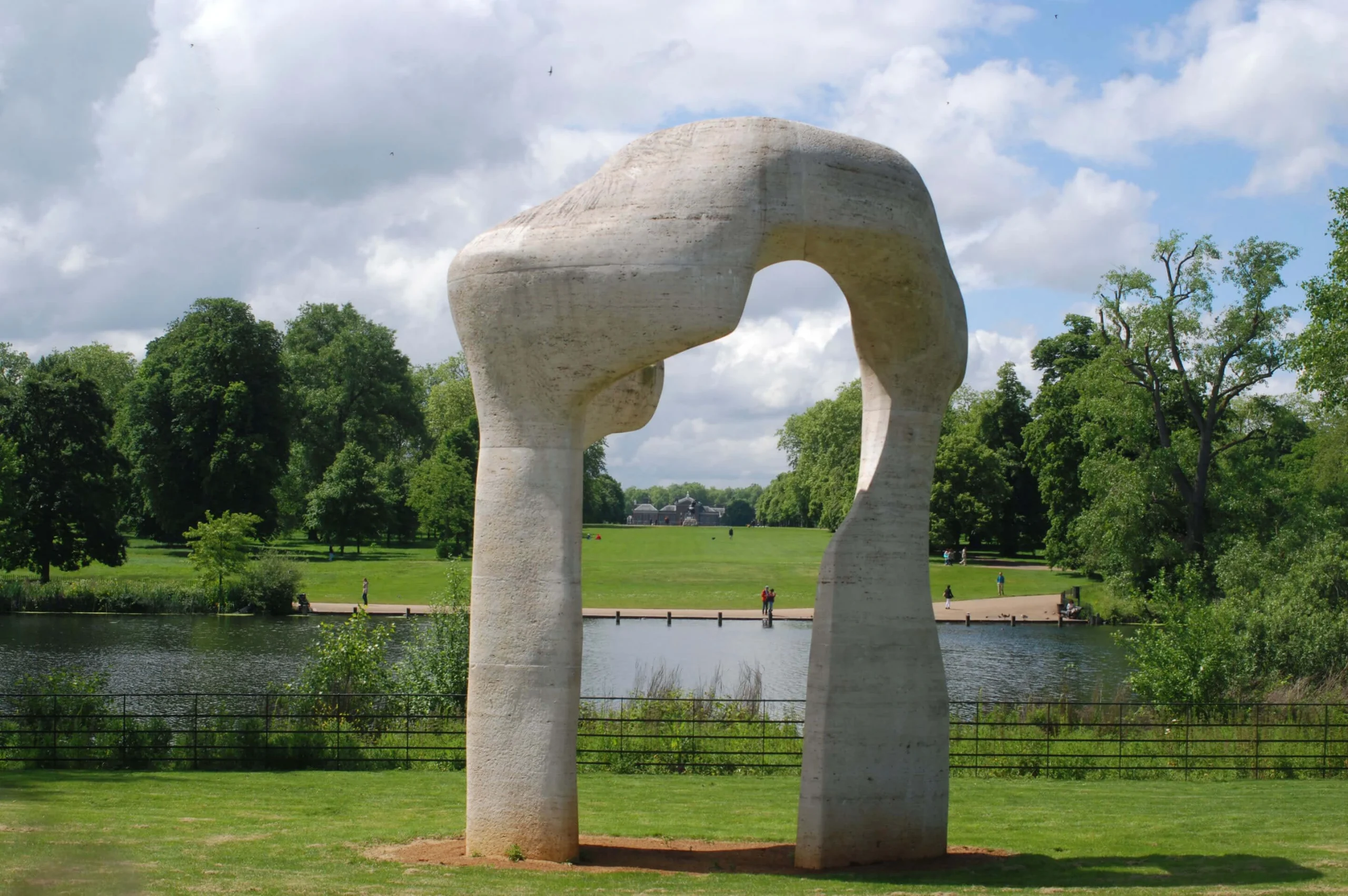 Pale stone arch framing a lake and trees