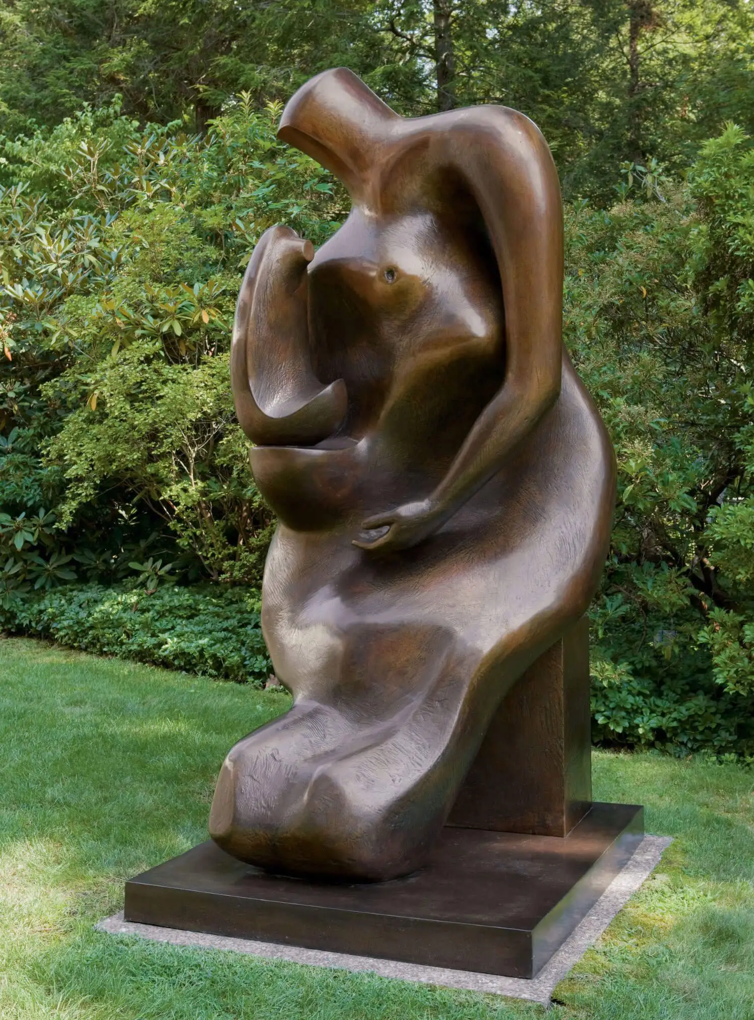 Pierced upright bronze figure among garden trees