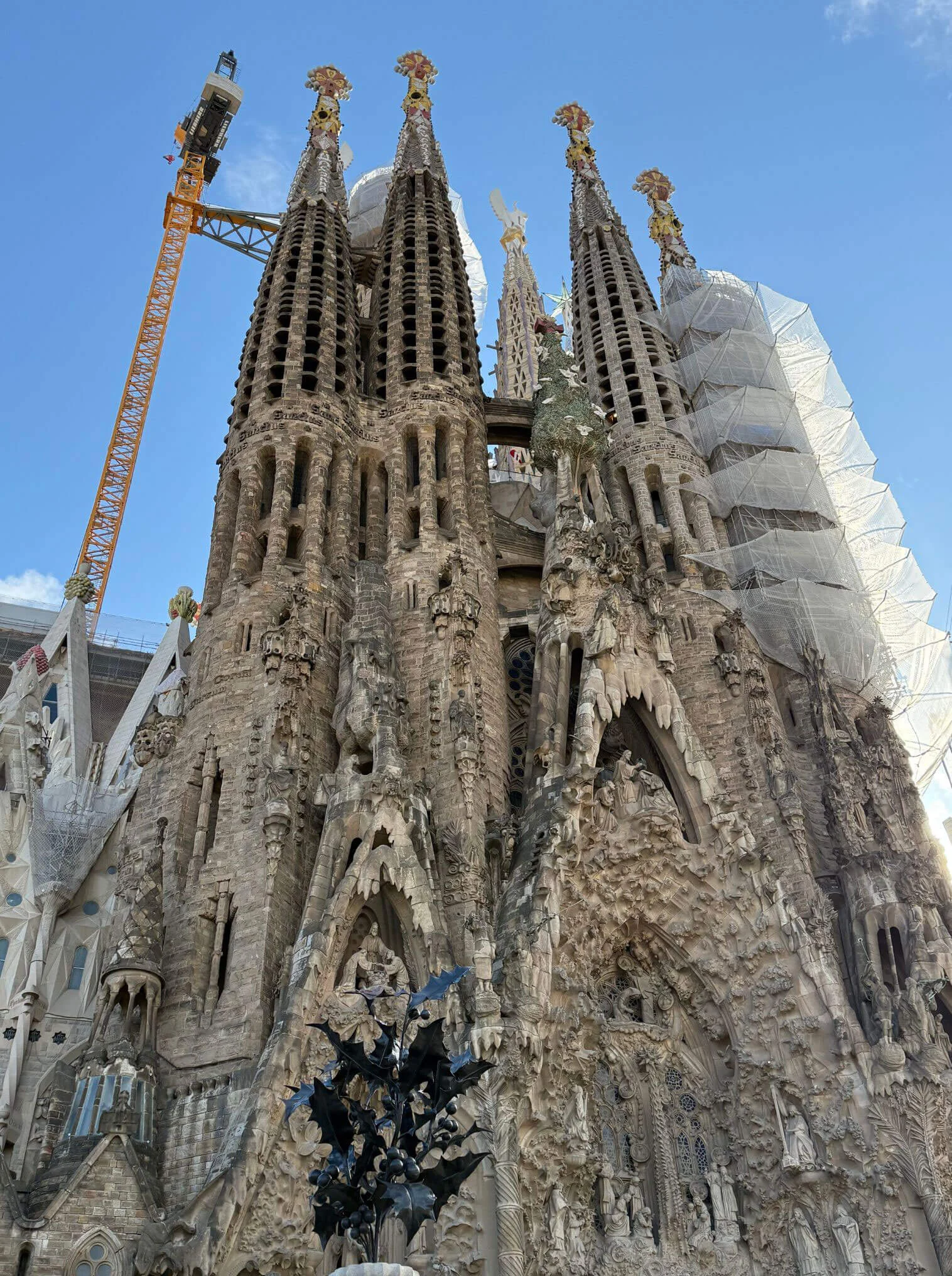 Tall basilica towers beside construction cranes