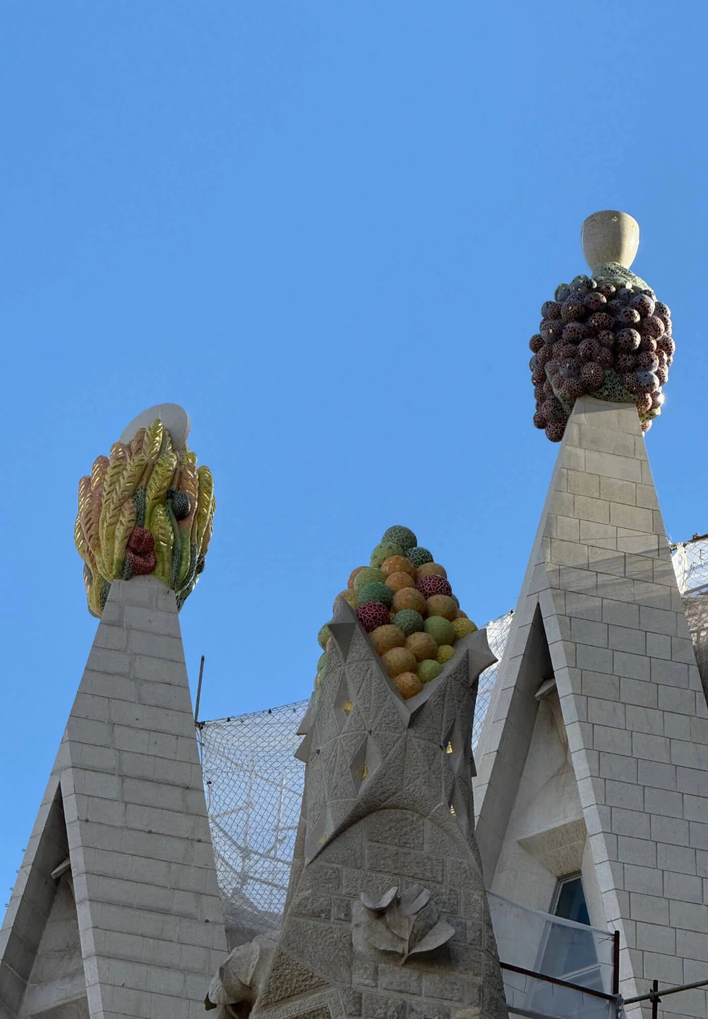 Colourful sculptural finials above pale stone pinnacles
