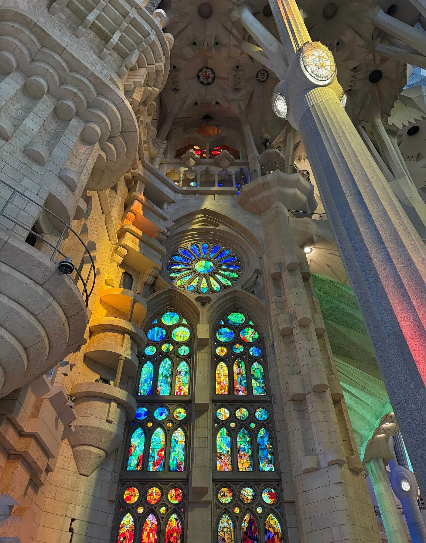 Cool stained-glass windows behind sculpted interior columns