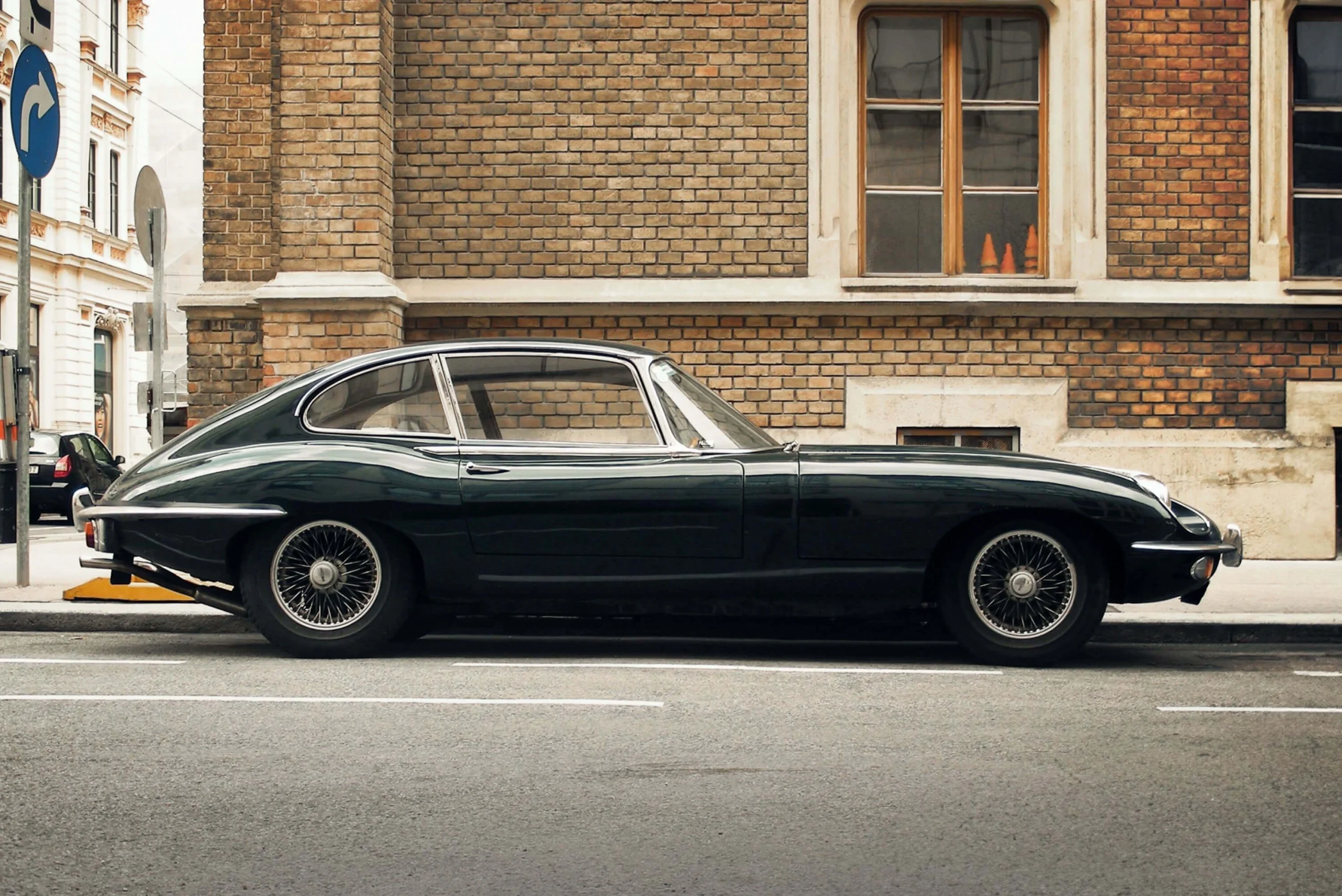 Side profile of a dark Jaguar E-type coupe