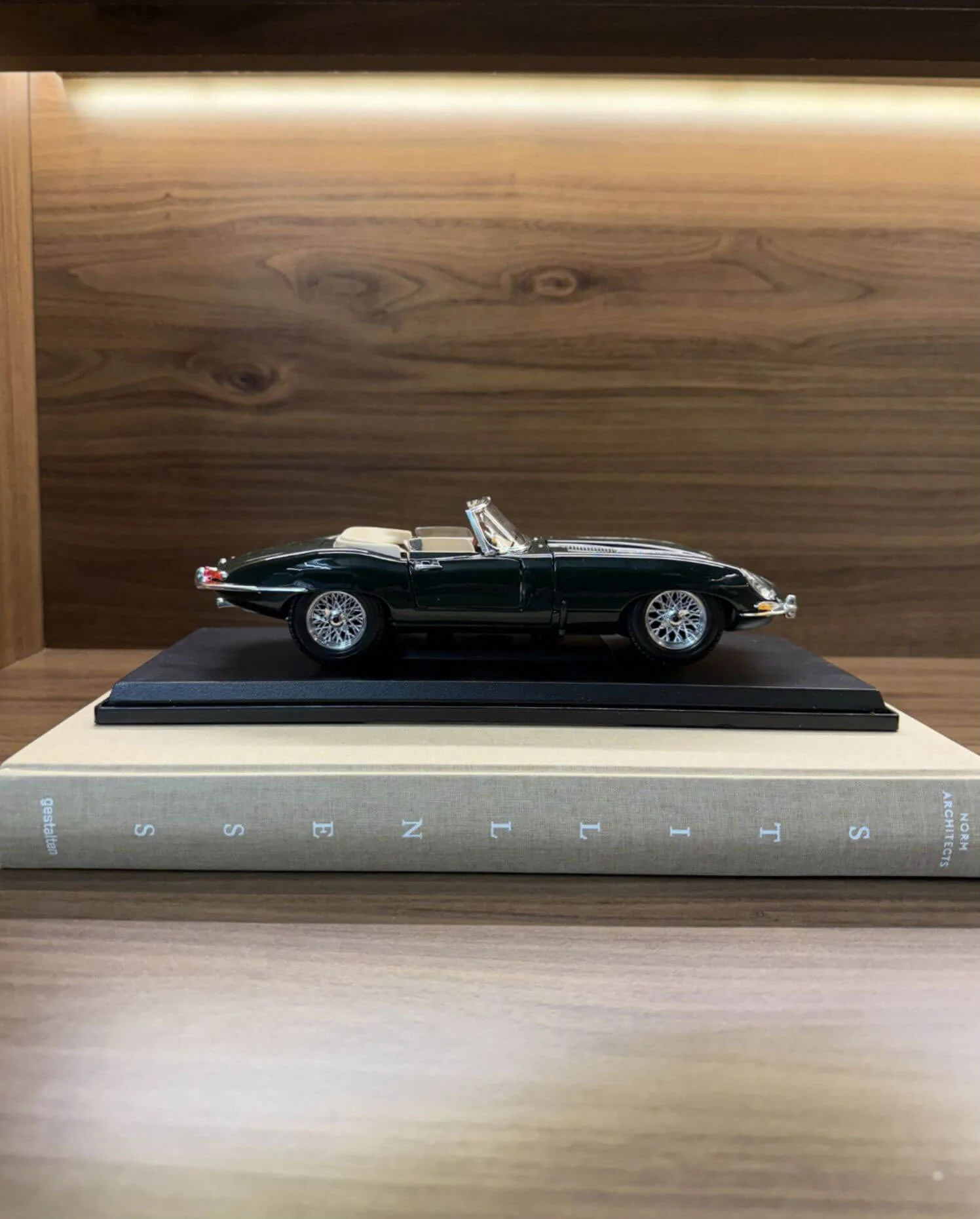 Classic sports car displayed on a museum platform
