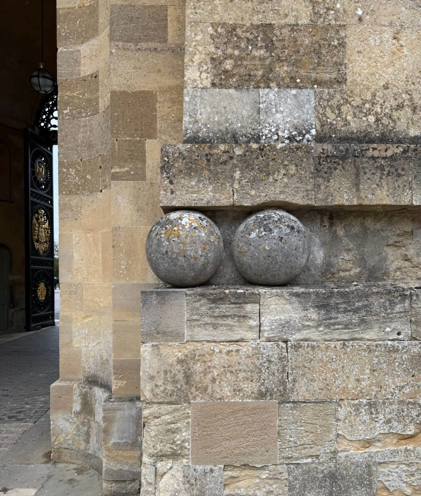 Carved stone spheres set into a masonry wall