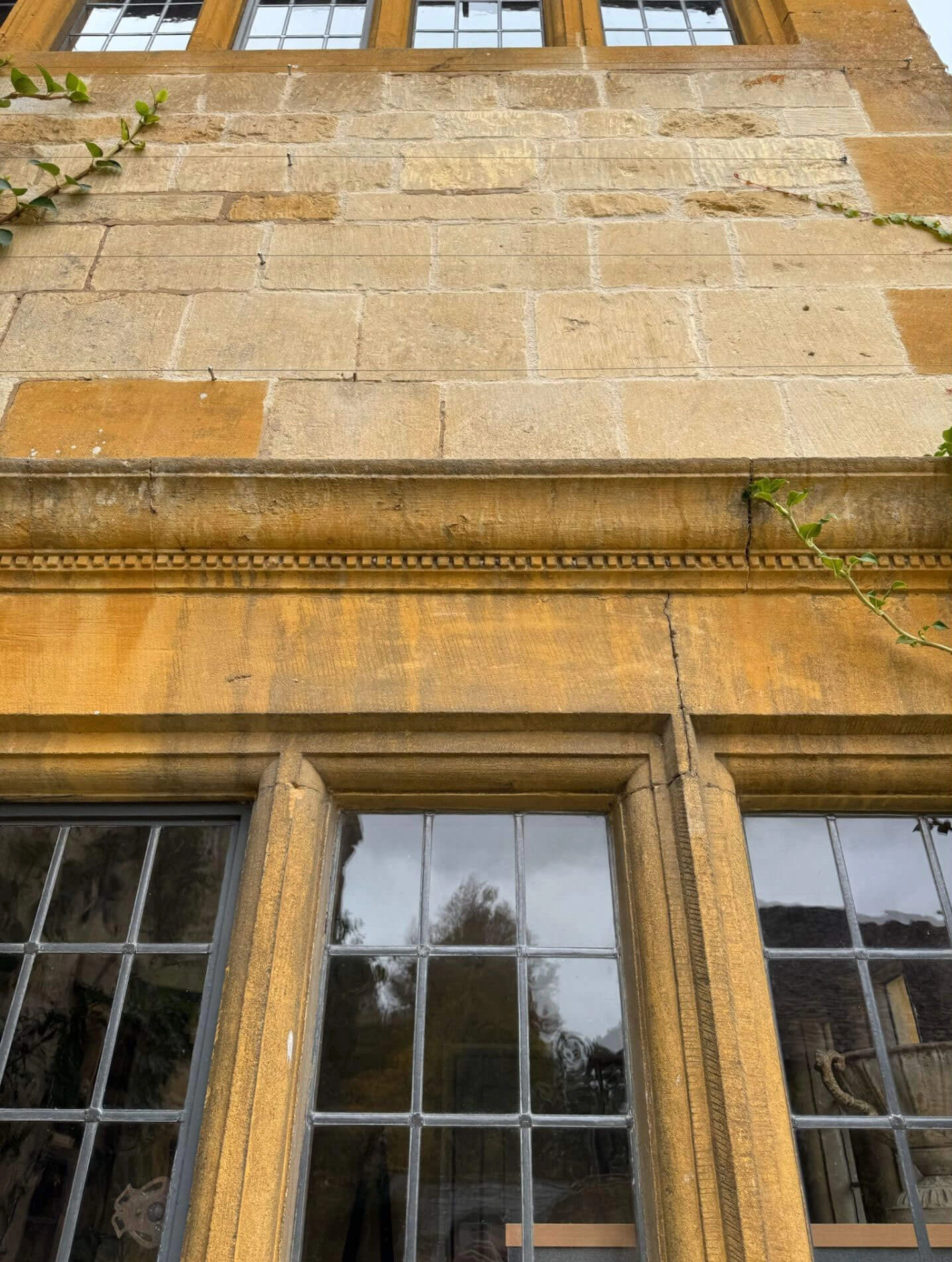 Carved stone detailing above leaded windows