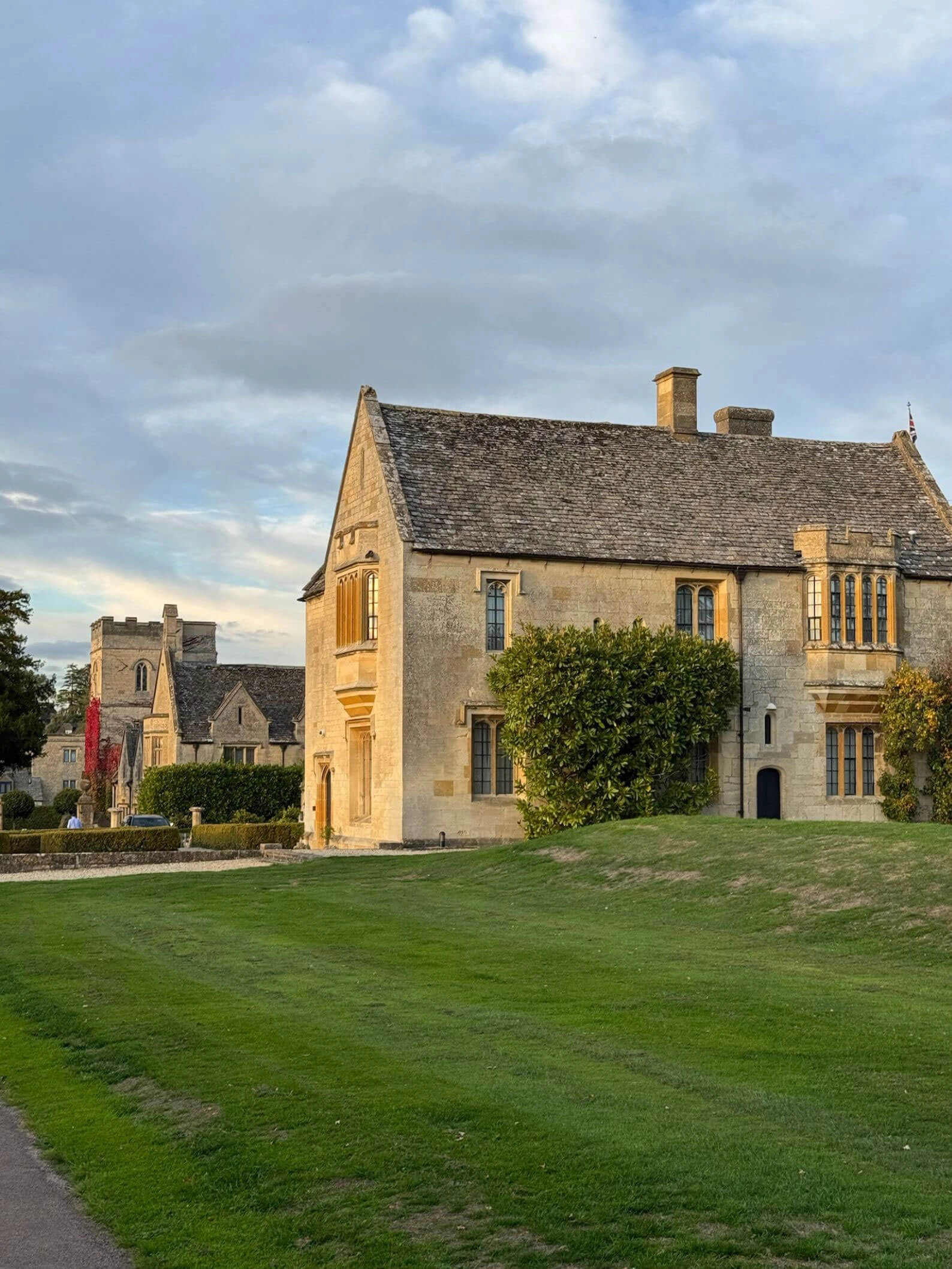 Lawn beside a stone manor wing