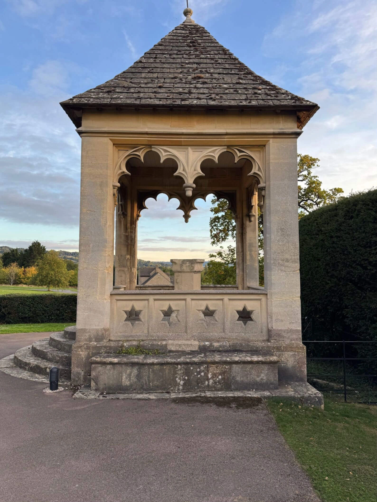 Small stone garden pavilion with carved open arches