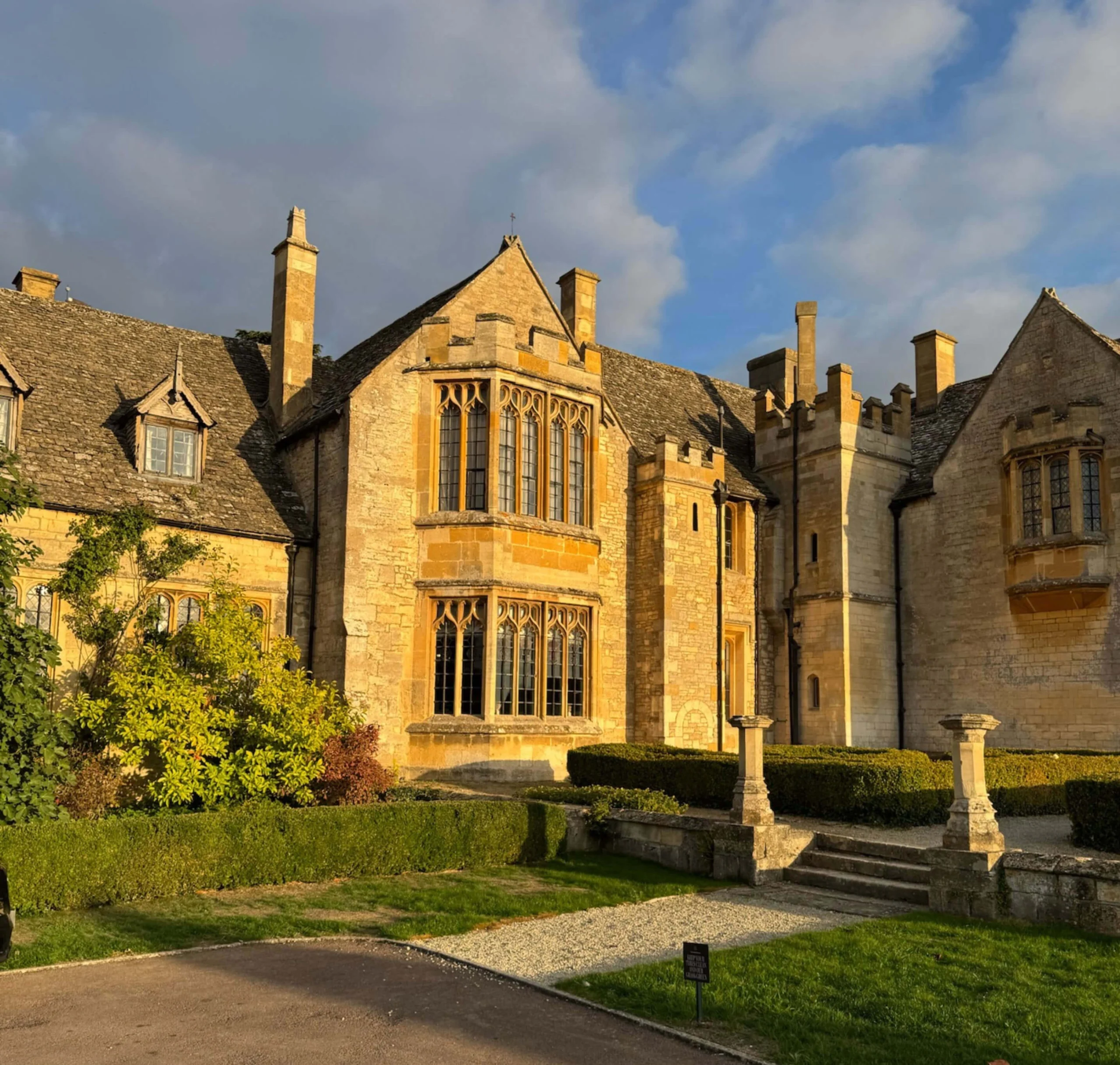 Sunlit manor facade with towers and projecting bays