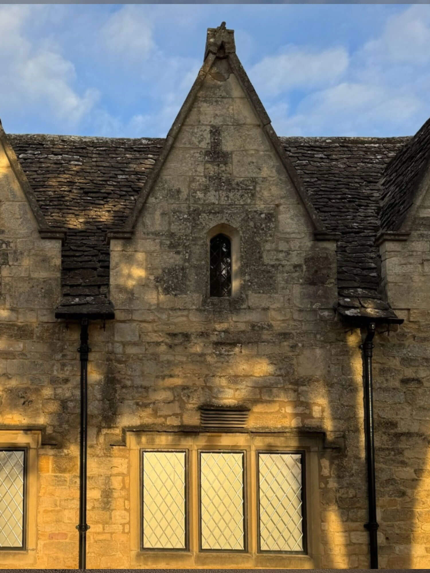 Narrow gabled facade with a rooftop finial