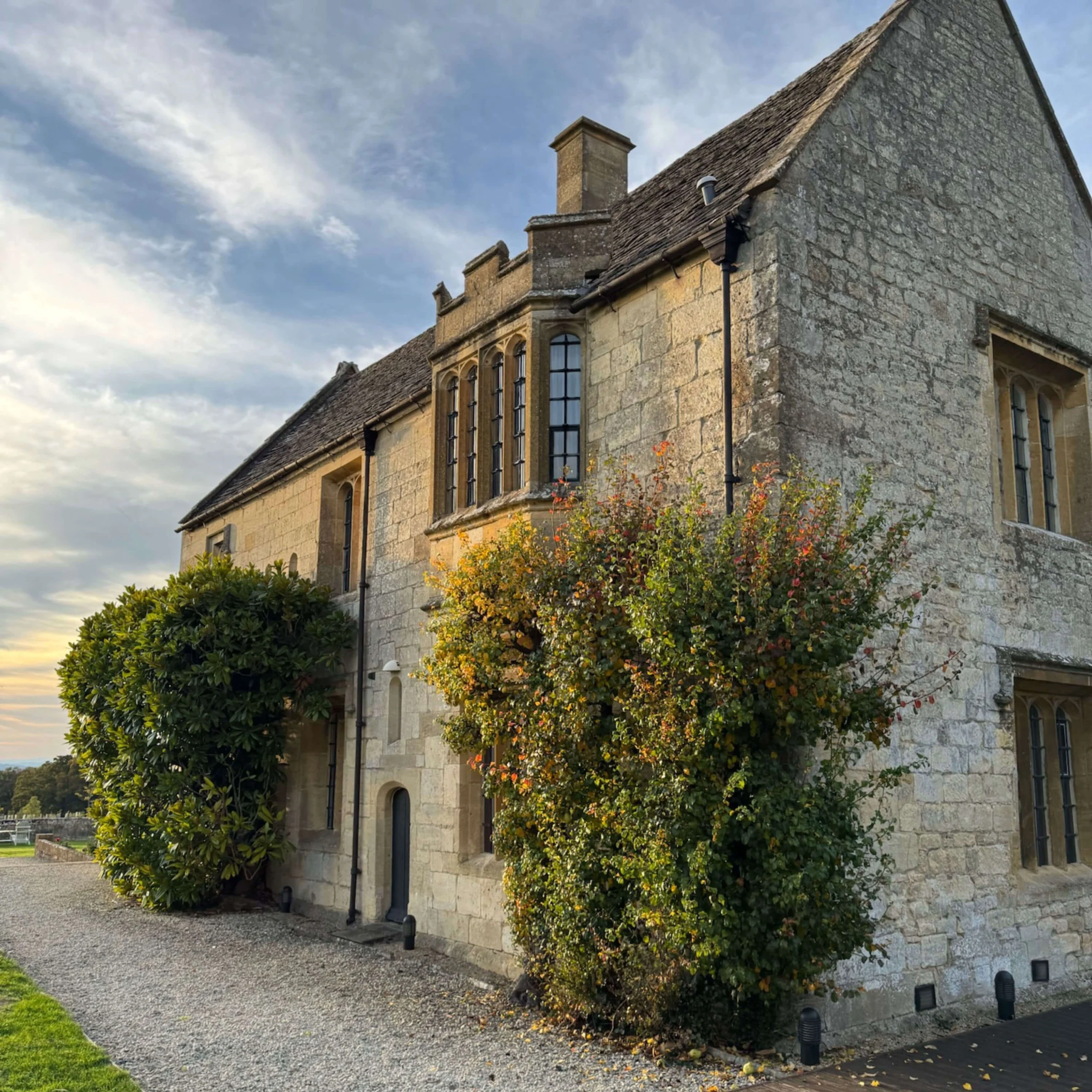 Stone cottage wing with climbing plants