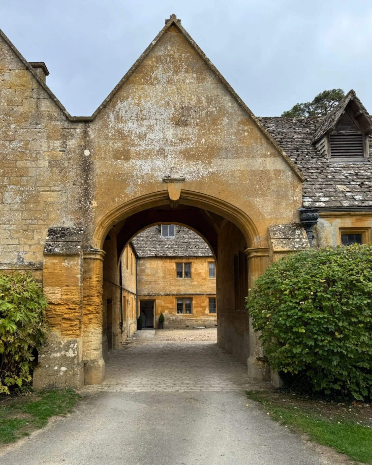 Arched stone gateway opening onto a courtyard