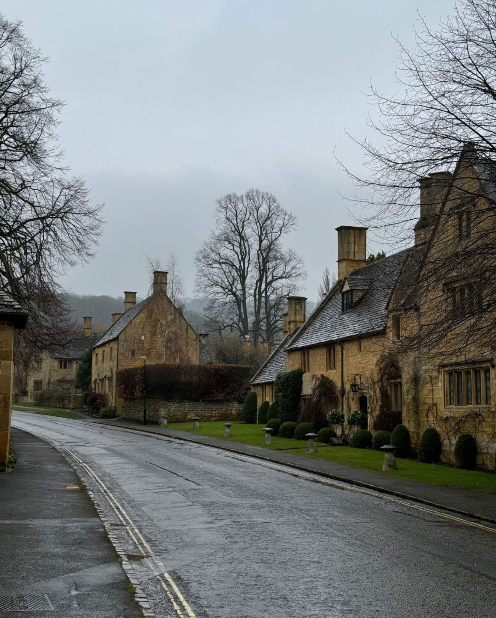 Quiet village road lined with stone cottages