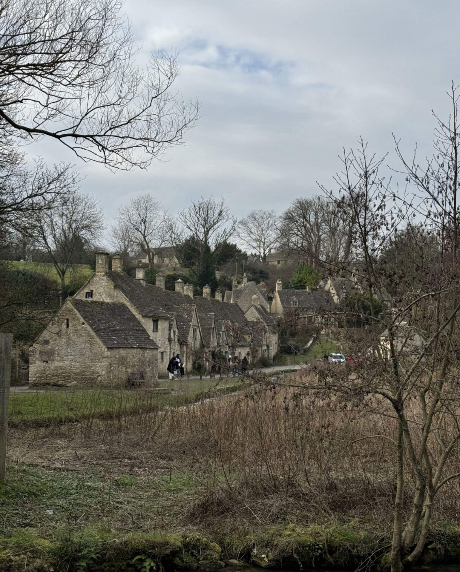 Stone village houses across a winter garden