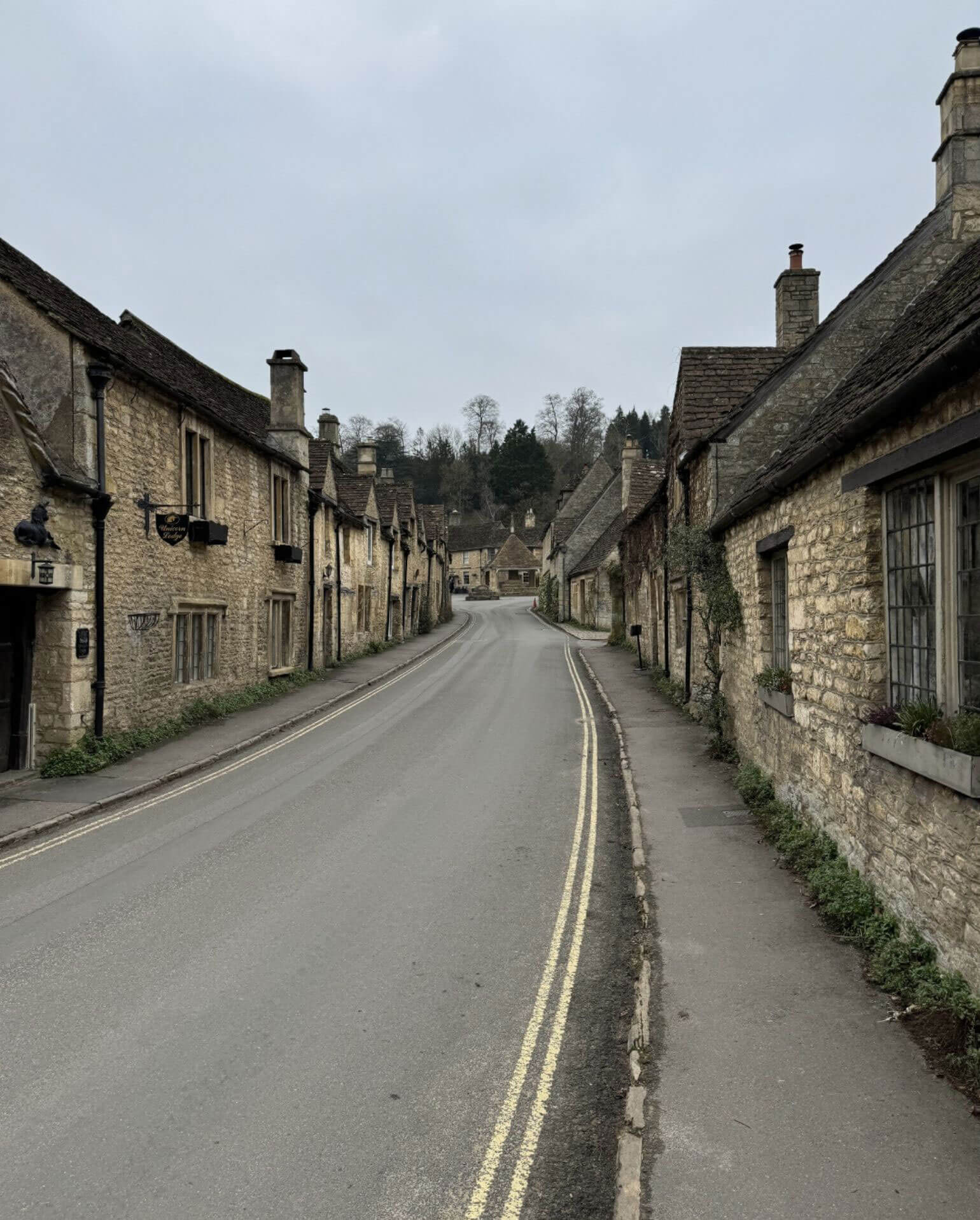Village street lined with honey-coloured stone houses