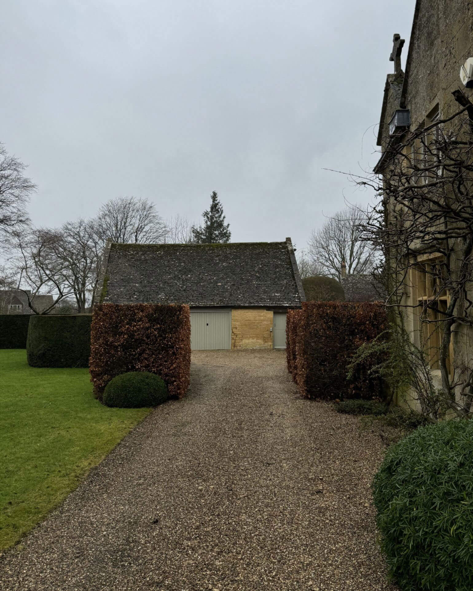 Gravel path leading to a small stone outbuilding