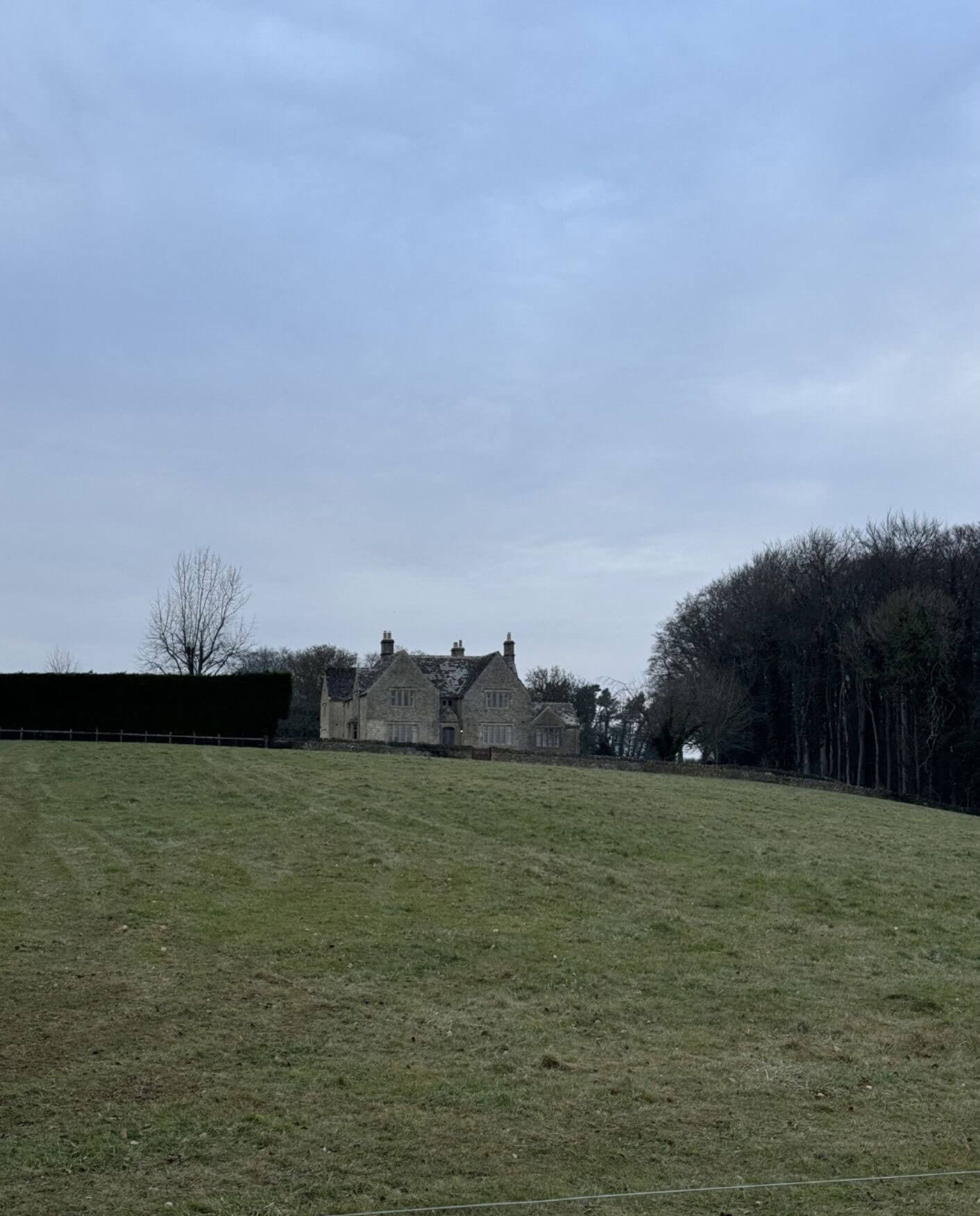 Distant country house across an open field