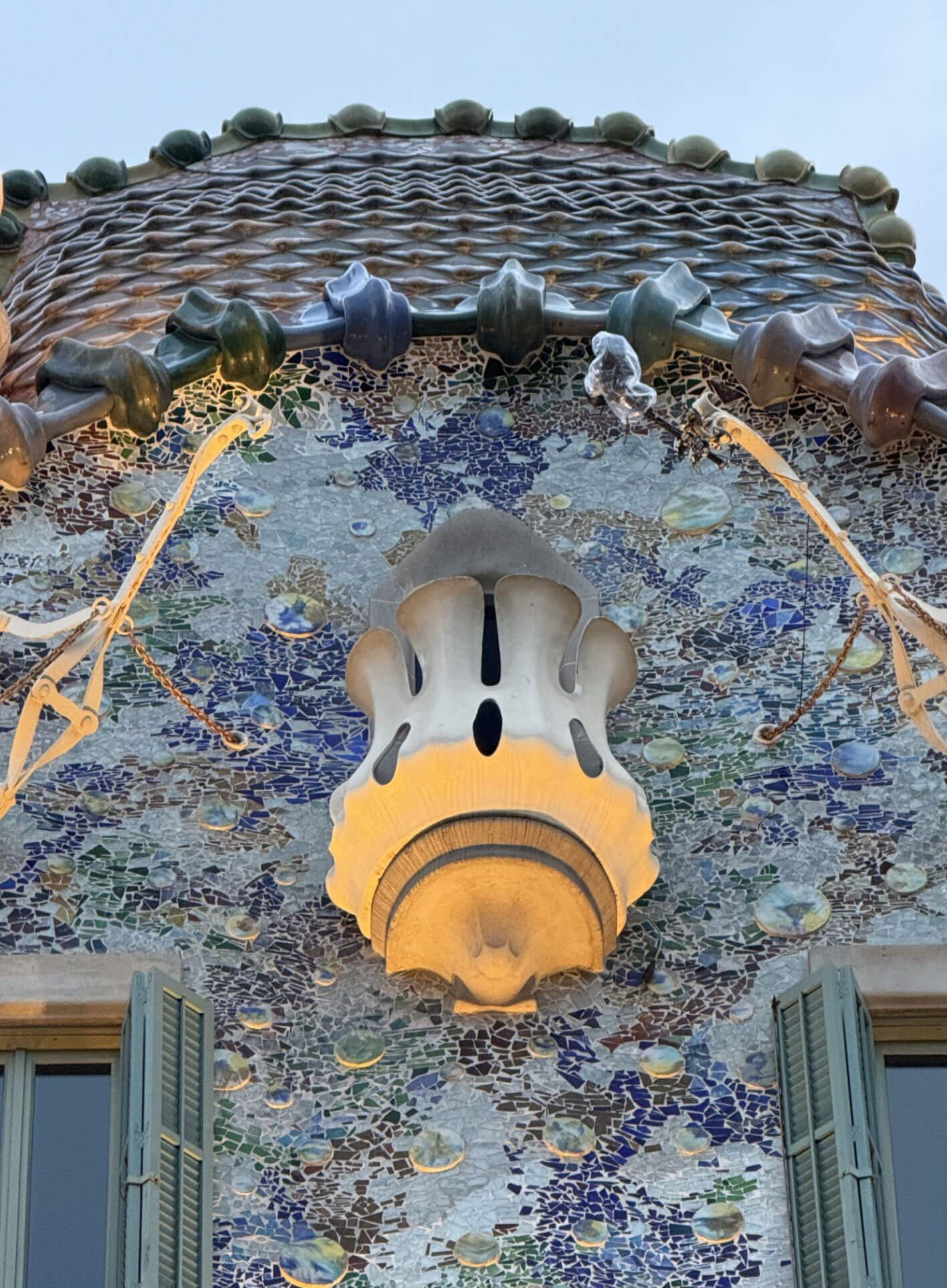 Curved tiled roof and rounded balcony on the facade