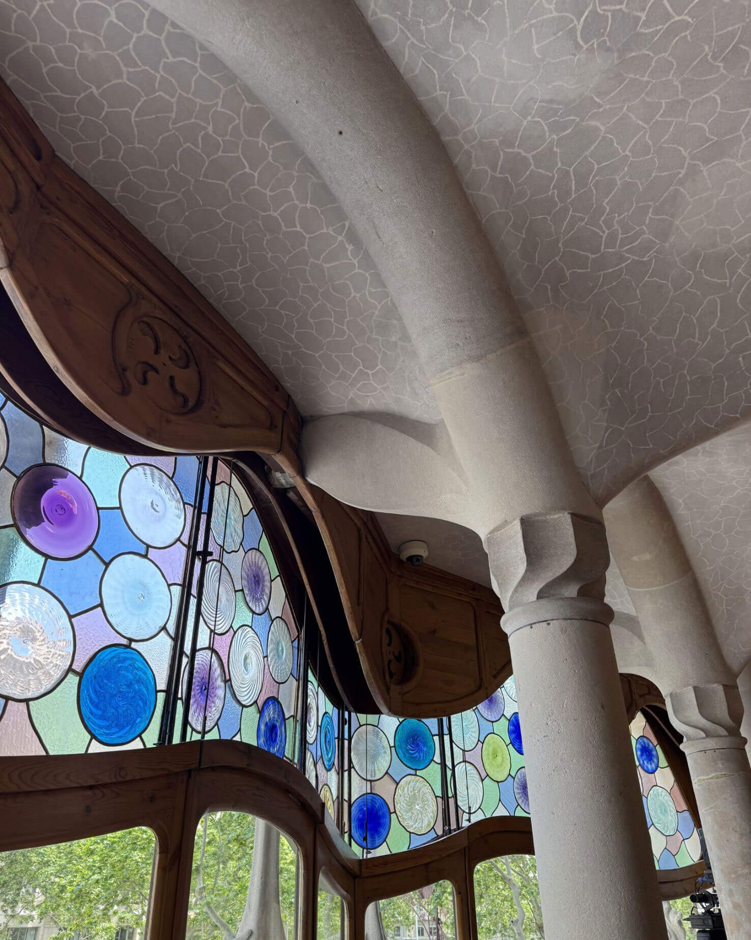 Curved interior ceiling above stained-glass windows