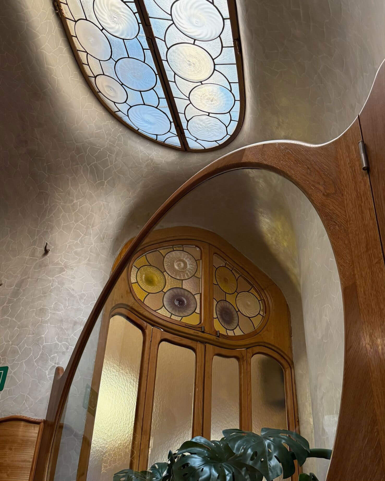 Sculpted timber doorway beneath an oval skylight