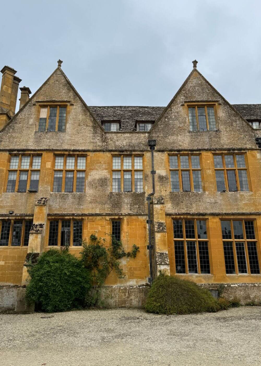 Twin gables and mullioned windows overlooking a courtyard